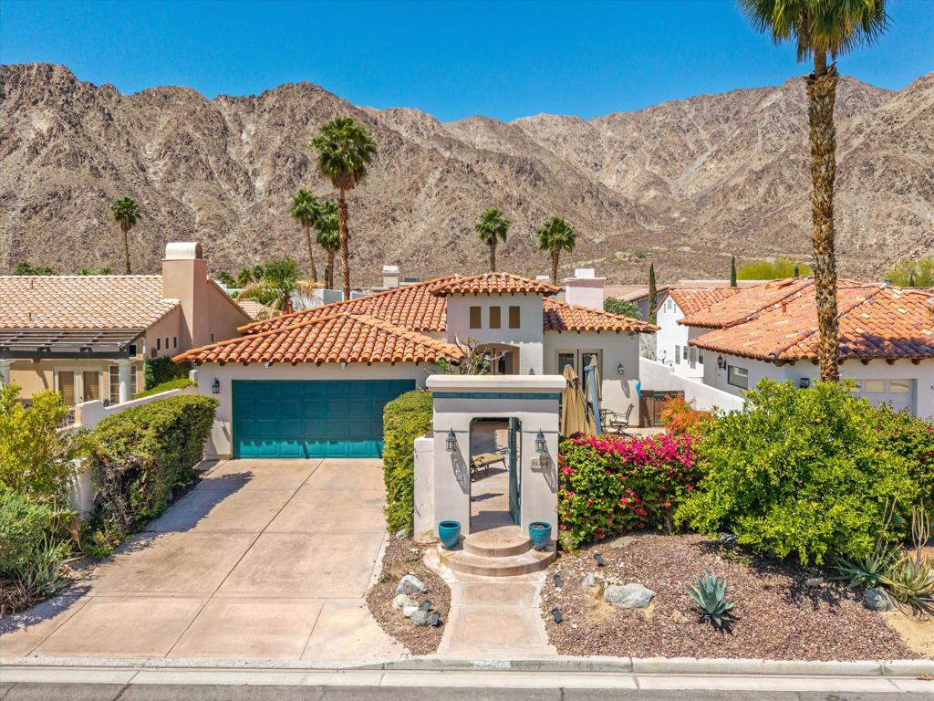 Nestled in the tranquil enclave of Yucatan Cove, this Mediterranean-inspired residence offers the ideal seasonal escape--elegant, sunlit, and effortlessly livable.Beyond a private courtyard entry, soaring ceilings and arched passageways introduce an airy interior where natural light fills every corner. The open-concept design connects the great room, chef's kitchen, and dining space with ease, creating an inviting flow for everyday living and entertaining alike.Outdoors, a resort-style setting awaits. Framed by swaying palms and mountain vistas, the yard offers a shimmering pool and spa, a patio for dining or lounging, and the perfect backdrop for both sunrise coffee and golden hour gatherings.The spacious primary suite is a true retreat, complete with direct patio access, a spa-like bath, and generous closet space--tailored for longer stays. Two guest bedrooms provide privacy and comfort for visiting friends or family.Thoughtfully designed for low-maintenance living and perfectly suited for a lock-and-leave lifestyle, this home is just minutes from Old Town La Quinta, championship golf, tennis, and miles of scenic hiking trails. A rare opportunity to experience the beauty, serenity, and convenience of the desert--season after season.