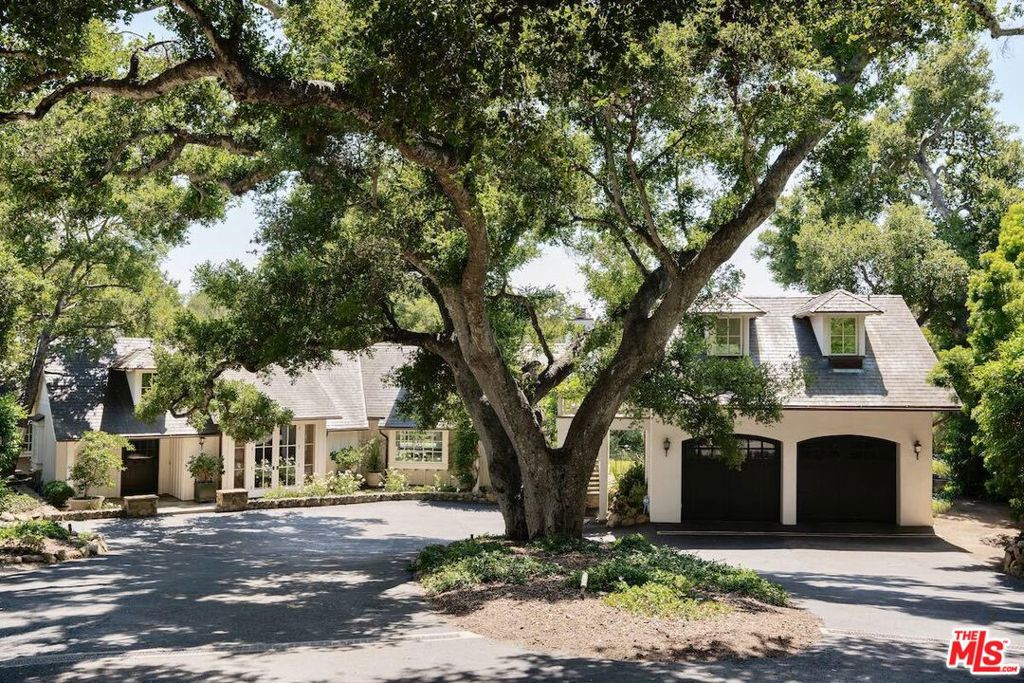 Located in the heart of Montecito's Golden Quadrangle, this private and tranquil 1+ acre retreat epitomizes Montecito's ethos of refined yet relaxed living. The 3bed/4 bath main residence seamlessly connects to the outdoors, allowing for optimal enjoyment of the natural beauty of the surrounding landscape (it currently lives as a 1-bedroom house - 2 bedrooms are currently converted into a large closet).Complete with a charming 2 bed/2 bath guest cottage and separate studio with kitchenette and bath , the home's classic California architecture and resplendent interiors offer a laid-back elegance.Tucked within a canopy of oak trees, this private oasis is just minutes from both the Lower and Upper Villages of Montecito, hiking trails, and a mere stone's throw away from the renowned San Ysidro Ranch Resort. Enjoy the solitude of this idyllic property while being just moments away from the vibrant life and all the unprecedented amenities that Montecito has to offer.The soaring living room exudes grandeur, with vaulted ceilings and exposed trusses, an exquisitely detailed stone fireplace, and large windows and French doors accessing two inviting outdoor terraces one with a trickling fountain and the other, with an outdoor fireplace. Additionally, a Christopher Peacock-designed chef's kitchen boasts hand-crafted cabinetry and top-of-the-line professional appliances. Off the kitchen, you'll find a gracious family room with a beautiful stone fireplace containing a herringbone brick firebox, replete with two sets of French doors leading out to both the front of the home and the backyard. On the other side of the kitchen, there is a spacious dining room with French doors to the front gardens of the home, perfect for hosting formal and informal dinner events.The primary suite is bathed in natural light, featuring large French doors framing breathtaking views of the backyard and mountains, opening to a private terrace. An expansive en-suite bathroom boasts classic, yet modern finishes, including marble countertops, a freestanding tub, and a walk-in shower with picturesque windows showcasing the natural setting.Designed by the premier Los Angeles closet designer, Lisa Adams and constructed at a considerable expense, the primary closet spans nearly 500 square feet following a recent conversion of the two guest bedrooms to create an expansive, one-of-a-kind space, meticulously curated to store and showcase one's wardrobe. Rows of custom-built shelving and cabinetry offer a dedicated place for each article of clothing and accessory. This designer closet is the epitome of high style and thoughtful organization though could be easily converted back to the original 2-bedroom, 2-bathroom configuration.Nestled within the picturesque landscape of the property, a spacious, renovated vintage 2-bedroom guesthouse cottage offers an enchanting and private escape for your guests. The cottage is a harmonious blend of traditional charm and modern luxury. Step inside, and you'll find two well-appointed bedrooms, a large, comfortable living area, and a fully equipped and updated kitchen. Vaulted ceilings add to the open atmosphere, and an original stone fireplace adds a touch of warmth on cooler evenings. As you step outside onto the private back patio, you'll discover a spa surrounded by lush greenery.Perched above the garage, a detached studio offers additional space for guests or home office and includes a bathroom and small kitchen area. A large floor-to-ceiling window provides an abundance of natural light while framing the picturesque backyard setting. Whether it's a quiet place to work, a cozy hideaway for reading, home gym, or an artist's creative space, this studio provides many options.1845 East Mountain Drive. A premier address offering classic Montecito living at its finest.