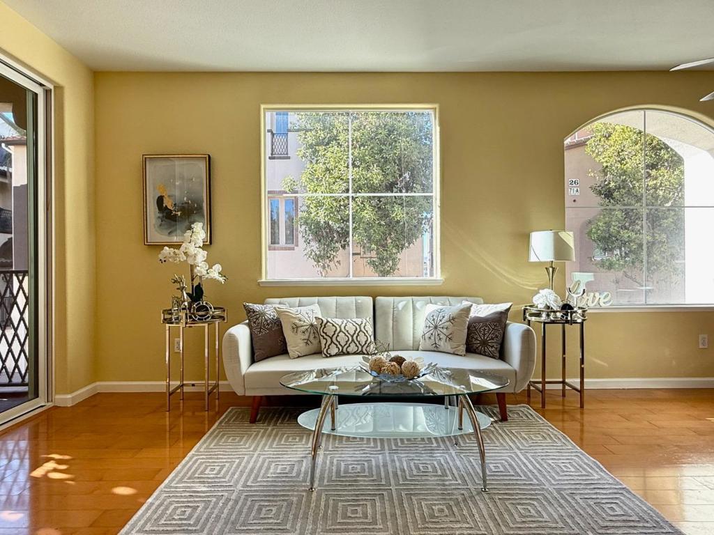 This stunning corner townhouse in Silicon Valley is a beacon of modern living. It features three bedrooms, a den or office, and two full bathrooms. The home sits above a large, insulated two-car tandem garage. Inside, you'll find a gourmet kitchen, beautiful floors, and elegant tiling. The bright living room opens to a cozy balcony, and a versatile bonus room is located downstairs. Enjoy fantastic views from every window. The location is unbeatable. You can walk to the Great Mall, a movie theater, shops, restaurants, and parks. Commuting is simple with quick access to highways 237, 880, 680, and 101. The VTA Bus, VTA Light Rail, BART and AMART are also just a short stroll away. The home is also just minutes from the proposed Google campus in downtown San Jose. The open house is this Saturday and Sunday from 1-4 PM.