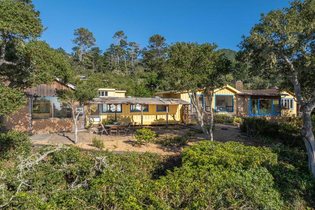 First Time on Market in 70 Years - Carmel Highlands Retreat with Ocean Views. Set on over an acre bordering Point Lobos State Reserve, this 2,213 sq ft home offers rare privacy and stunning natural surroundings. The two-bedroom, two-bath main house is filled with light and scenic views, complemented by an attached adobe studio with its own bath and kitchenette. Enjoy ocean vistas, ancient oaks, and abundant wildlife all just minutes from Carmel yet feeling worlds away.