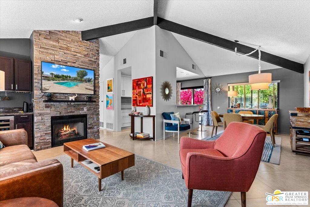 Welcome to 2150 N Sunshine Circle in Sunshine Villas, a gated community in central Palm Springs designed by renowned desert architect Hugh Kaptur. This 120-unit community offers convenience and exceptional value all with expansive views of the San Jacinto mountains with proximity to downtown including shopping, museums, dining and entertainment. 2150 N Sunshine Circle is a fully updated home on one level featuring mountain views through double-paned windows from 3 directions -- south, north and west. This is an attached home with the only shared wall being in the garage -- no shared walls in the living space. The spacious living area is highlighted by vaulted ceilings (a Hugh Kaptur trademark), a stacked stone fireplace and a convenient bar for entertaining. The modern, recently updated kitchen features stainless appliances and expansive quartz counterspace and custom cabinetry. This home includes 3 bedrooms and 2 full bathrooms in 1,342 square feet and is well-suited for either a primary or secondary residence where one can relax on either patio and take in the vistas for which Palm Springs is known. As an added bonus Sunshine Villas is adjacent to the Prescott Preserve, perfect for nature lovers and active lifestyle enthusiasts. The home also includes a garage for 1 vehicle with space in the driveway for a 2nd. The community includes 4 pools & spas, tennis/pickleball courts with the homeowners association providing earthquake insurance, tv/internet, water and roof maintenance.