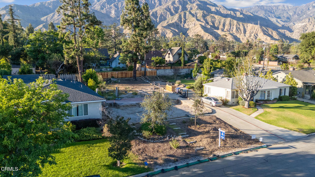 Set in the Country Club area on a street of mostly standing and inhabited homes, this luscious lot offers mountain views and two amazing conifers, the perfect Altadena spot to build, right at the base of the foothills. Surrounded by larger homes, the previous house was 1392 square feet with 3 bedrooms and two baths. Already surveyed and deemed, by Cal Fire, to not be in a high fire zone. This lot offers endless possibilities and situated in an established community, many of whom have lived there for decades.