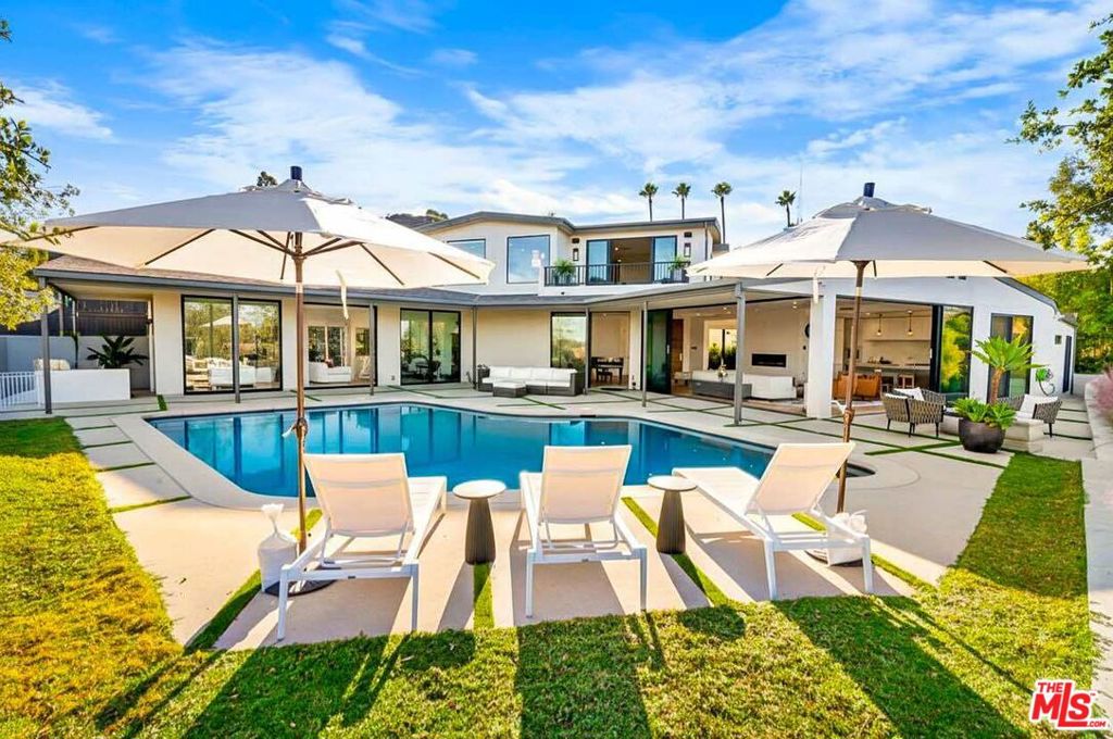 ELEVATED LUXURY WITH VIEWS THAT DEFY EXPECTATION. From the moment you cross the threshold, you are met with an uninterrupted horizon stretching from downtown Los Angeles to the San Fernando Valley and the mountains beyond. Sunlight cascades through walls of Fleetwood glass, guiding you forward as though the views themselves are drawing you deeper inside.The living spaces unfold with effortless flow, each one open yet intimate. Stand in the great room and the city reveals itself in every direction. A few steps more and the line between indoors and outdoors disappears. The pool terrace welcomes lingering afternoons in the sun and evenings illuminated by the city lights below.At the heart of the home, the kitchen is both a showpiece and a gathering place. European cabinetry, beveled Dekton Rem counters, and a suite of Miele appliances invite you to cook, entertain, and enjoy. Every surface and detail reflects careful thought and precision. Two primary suites create the feeling of a five-star resort, each with its own terrace for sunrise or sunset views. Spa-inspired Porcelanosa baths, glass showers, soaking tubs, and generous walk-in closets complete the retreats. The home theater provides a private escape, while integrated smart systems ensure comfort, security, and ease. Set at the end of a quiet cul-de-sac in one of Los Angeles' most coveted hillside enclaves, this residence offers rare privacy within minutes of Beverly Hills and downtown LA. Imagine waking up each morning to this horizon, stepping onto your private terrace, and truly calling this extraordinary residence your home. Why not make it yours today and start living the life you've been imagining?