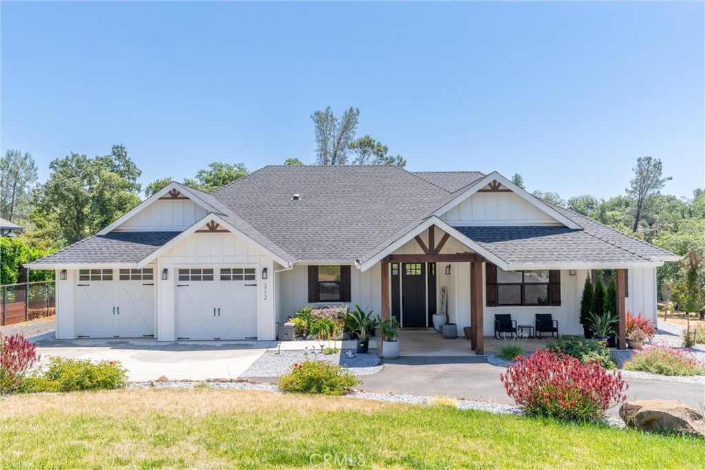 Welcome to 212 Valley View Drive where luxury meets functionality. This home is tucked back on a 1.46-acre, landscaped lot that features privacy shrubs, a circular driveway, and a spacious 541 sq. ft covered front porch. The home is 4 bedrooms, 2.5 bathrooms, and 2,348 square feet. When you step inside you will find an open, inviting interior with high ceilings - the perfect home for entertaining and relaxing. The living room features a raised hearth gas fireplace with a wood mantle, perfect for cozying up during the winter months. This home features LVP (luxury vinyl planking) flooring throughout, a whole house fan, an on-demand water heater, and central HVAC. The kitchen features a large island with bar top seating, a spacious walk-in pantry, stainless steel appliances, soft close cabinets and drawers, a farmhouse sink, and an adjacent dining area. The primary suite is spacious and offers access to the backyard. The en-suite bathroom has dual vanities flanking a custom barn door, a deep soaking tub, a rainfall walk-in shower, and a large attached walk-in closet with direct access to the laundry room for your convenience. There are three additional bedrooms for plenty of space, and a separate bathroom with dual sinks and a separate toilet and tub/shower. Outside you will find the large, partially fenced in backyard with a lawn, greenery, and a covered back porch. Further down you will find the gorgeous 30x40 shop with two roll up doors, perfect for entrepreneurs, hobbies, vehicles, or storage. This home provides ample amenities and is located in a peaceful neighborhood. Come check it out!