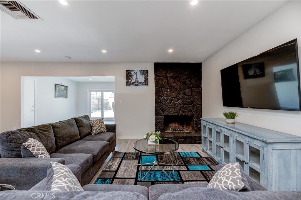 Discover a rare gem that blends modern living with smart investment potential at 19847 Arminta! This fully renovated residence, complete with a permitted ADU, is your chance to own a versatile property that delivers both comfort and financial rewards. Whether you're a first-time buyer, growing family, or savvy investor, this home offers unmatched value with the opportunity to offset your mortgage through rental income or expand your living space for loved ones. Step into the main house and be captivated by its bright, airy ambiance. Sunlight pours through energy-efficient double-pane windows, illuminating a spacious open-concept layout enhanced by sleek recessed lighting. The inviting living room centers around a striking gas fireplace with a chic stone surround, perfect for cozy evenings. The state-of-the-art kitchen is a chef’s dream, boasting gleaming quartz countertops, a stylish tile backsplash, a grand center island, custom cabinetry, modern pendant lighting, and top-tier stainless steel appliances. All four bedrooms in the main house are generously sized, bathed in natural light, and meticulously updated for modern comfort. The two full bathrooms have been transformed with high-end finishes, offering a spa-like retreat. Need extra space or income? The ADU, featuring a full bedroom and bathroom, is a game-changer. Rent it out to a reliable tenant for steady cash flow to help with mortgage payments, or use it as a private suite for extended family, guests, or a home office. Outside, the expansive backyard is an entertainer’s paradise. Impeccably designed with premium pavers, low-maintenance synthetic grass, a charming wooden pergola, and a built-in barbecue with stone veneer, it’s ideal for summer gatherings or tranquil relaxation. This home is move-in ready with upgrades galore: a newer roof, a robust 200-amp electrical panel with updated wiring, tankless water heaters, new copper plumbing, a modern HVAC system, and a convenient laundry room. For investors, the potential to rent both the main house and ADU offers exceptional cash flow. For homeowners, it’s a chance to live in style while building wealth. Don’t miss this unparalleled opportunity to own a turnkey property that checks every box. Photos were taken before the current tenants moved in and property is in similar condition.