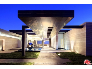 Private, gated and perched atop a promontory, this contemporary Trousdale estate offers panoramic views from downtown to the ocean. Sophisticated materials are used throughout, including white terrazzo floors, technology by Crestron, & Rheinzink garage doors. The family room with oak walls opens to stunning chef's kitchen with Miele appliances.Leading from the living room is a luxurious screening room. 5 bedrooms and 6.5 bathrooms, with staff quarters, glass wine cellar and a gym/office. The master suite with rift oak paneling, linear fireplace and Fleetwood pocket doors boasts a gorgeous view. The powder room is stunning with back lighted Onyx and venetian walls. The master bathroom features his/her vanities and a steam shower. The resort like backyard features a tiled infinity edge pool & jacuzzi. The outdoor cooking area has Viking appliances, linear fire feature, TVs, and seating area. One of a kind home. See private remarks for what is excluded from sale.