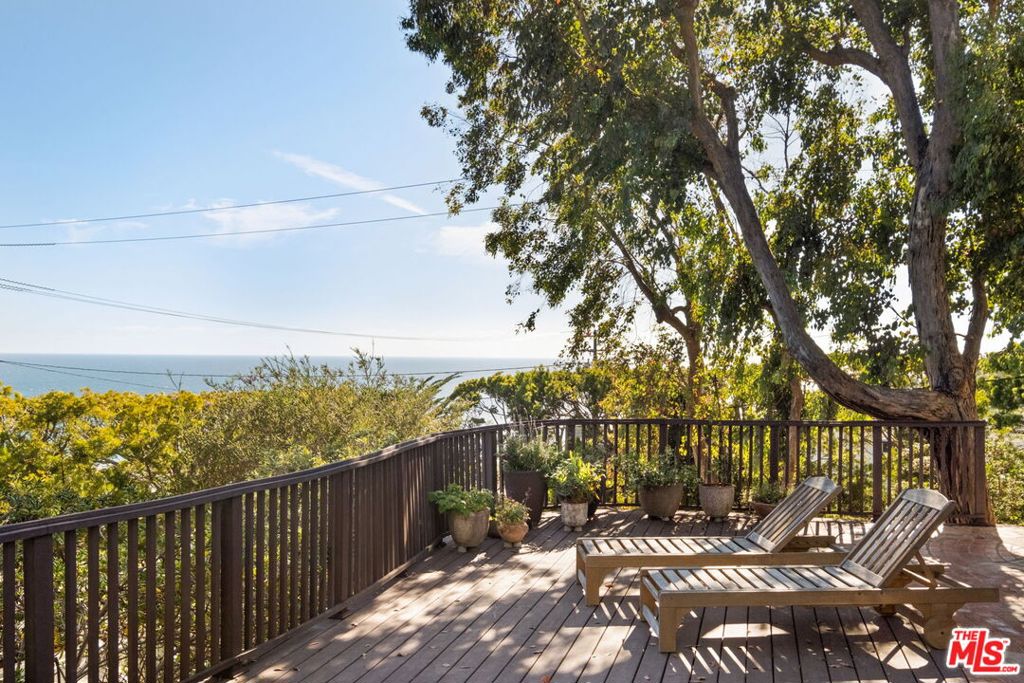 Cape Cod at County Line! First time on the market in 37 years - a rare commodity in this well sought after location with limited SFR's and neighboring properties selling over $20M. Don't miss this Incredible opportunity to acquire this adorable, warm, and ultra-private Cape Cod nestled across from renowned surf spot, County Line. Bright and spacious, this cozy 4 Bed/3 Bath spares no detail. Upon entrance, the generous living area with saltillo tile and custom wood burning fireplace awaits along with abundant natural light and ocean views by way of the ample windows and French doors throughout. Adjacent is the beautifully renovated kitchen complete with elevated finishes including cherry cabinetry, limestone countertops, and upscale appliances. The scenic mountain and ocean views resonate through all four bedrooms and continues through to the Trex decks and expansive backyard where you'll find a sweet enclosed vegetable and fruit garden surrounded by California native landscaping, winding brick and flagstone pathways embedded with sea glass, outdoor shower, and two stone water features which beckon birds and wildlife to the yard. To top it all off, this incredible parcel has a private gated driveway and fully finished 2-car garage with EV charging station, Tesla Powerwall for any unexpected outages, Solar Roof, newly installed Hardie Board non combustible siding, Roof sprinklers, and so much more. Truly a well thought out vision and a beautiful opportunity not to be missed! **Exterior currently being painted Cape Cod gray with white trim - new exterior photos and drone coming soon
