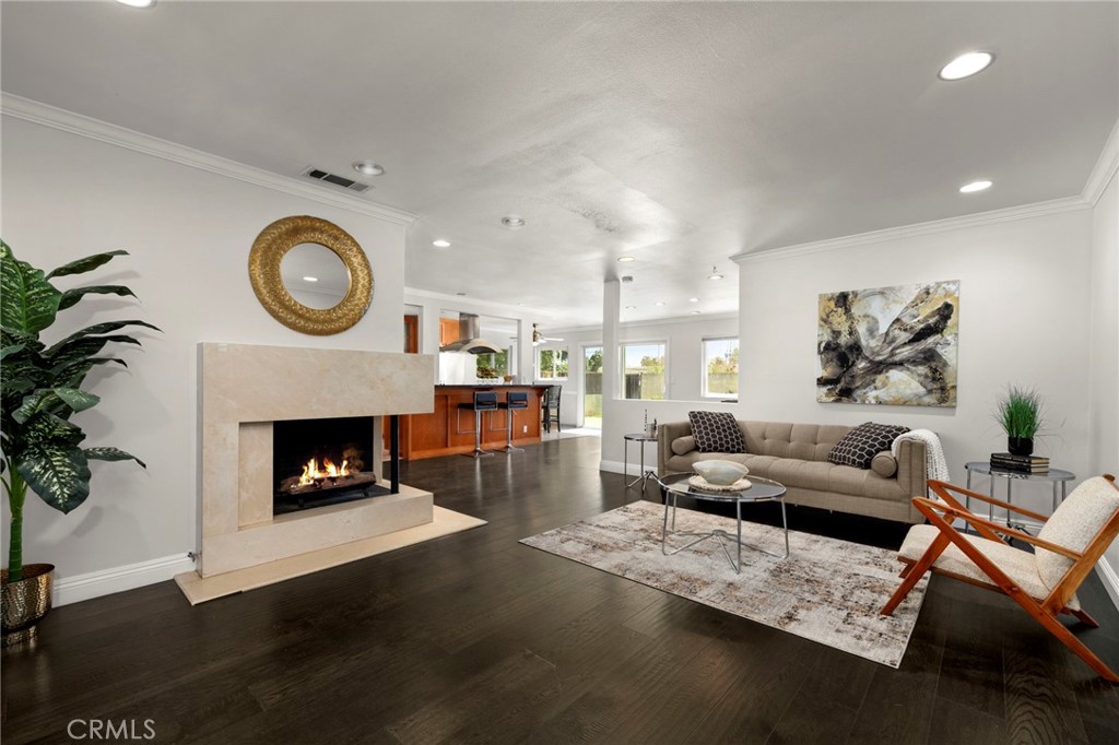 Welcome to this beautifully upgraded single-family home offering 4 spacious bedrooms, 2 bathrooms. Nestled in one of Long Beach’s most sought-after neighborhoods, this home combines comfort, functionality, and location. Inside, you will find a generous living room featuring recessed lighting and a cozy gas fireplace—perfect for relaxing or entertaining. Inside, the expansive great room seamlessly integrates a well-appointed kitchen with both formal and casual living areas, creating an effortless flow for everyday comfort and entertaining. Sliding doors open to a private backyard oasis, perfectly blending indoor and outdoor living for year-round enjoyment. A charming breakfast nook offers a more casual dining option. Enjoy the rich look of dark hardwood floors (installed in 2018) throughout the home. All four bedrooms are impressively sized, filled with natural light, and complemented by two bathrooms. Practical features include ample hallway storage closets, a tankless water heater, and a new roof (installed in 2020). The insulated and drywalled 2-car garage comes with built-in storage cabinets, adding even more functionality to this incredible home. Enjoy the outdoors with your private backyard retreat, which backs up directly to a tranquil greenbelt and the San Gabriel River trail—offering a peaceful path that leads straight to the beach. This is a rare opportunity to own a turnkey home in a prime location, close to parks, trails, and the best of Long Beach living. Don’t miss out!