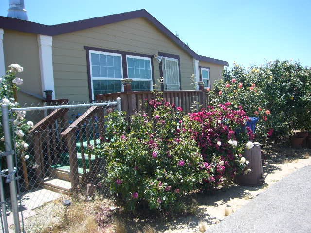 Welcome to the serenity of beautifiul Pearblossom in the southeast Antelope Valley. Situated on a higher elevation affording incredible view of the valley. With just over one acre, this manufactured home has many upgrades: from the living/dining rooom with fireplace; to the large, open kitcenn with granite countertops, lots of cupboards and in kichen dining area; to the family room with fireplace; to the master suite with sitting area and large master bathroom with closets; to two separate bedrooms connected by a Jack and Jill bathroom; to the indoor laundry area, The property has a semi-circular black top driveway and gated entrance to the back yard. Concrete slab in back yard for outdoor entertaining.