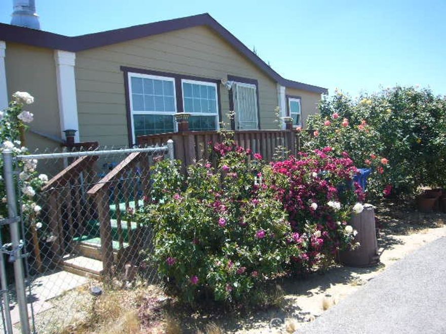 Welcome to the serenity of beautifiul Pearblossom in the southeast Antelope Valley.  Situated on a higher elevation affording incredible view of the valley.  With just over one acre, this manufactured home has many upgrades:  from the living/dining rooom with fireplace; to the large, open kitcenn with granite countertops, lots of cupboards and in kichen dining area; to the family room with fireplace; to the master suite with sitting area and large master bathroom with closets; to two separate bedrooms connected by a Jack and Jill bathroom; to the indoor laundry area,  The property has a semi-circular black top driveway and gated entrance to the back yard.  Concrete slab in back yard for outdoor entertaining.