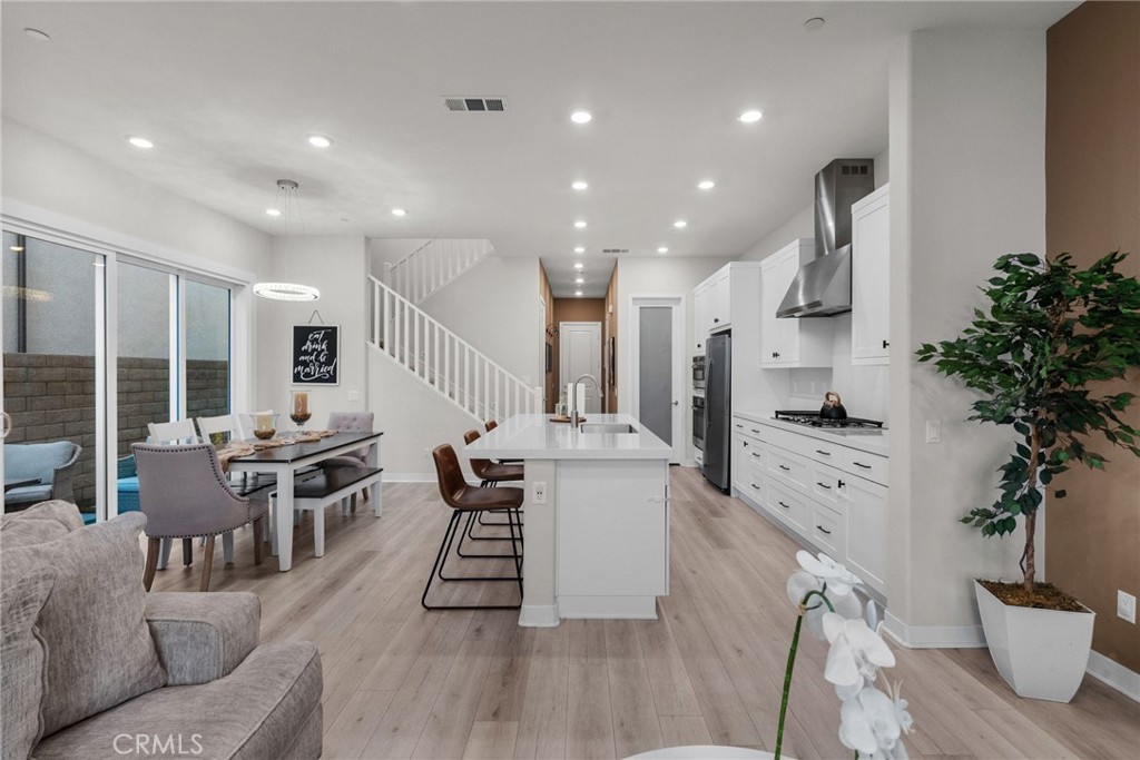 This stylish 2022 townhome combines modern design with everyday comfort. The open floor plan features high ceilings, abundant natural light, upgraded vinyl plank flooring, and a gourmet kitchen with quartz counters, stainless steel appliances, and a walk-in pantry. The dining area opens to a private, low-maintenance yard with pavestone and turf. Upstairs offers a versatile loft, a spacious primary suite with oversized walk-in closet, spa-like bath, and covered patio, plus two additional bedrooms with walk-in closets.
Additional features include a two-car garage with Tesla EV charger, tankless water heater, smart home technology, Ring security, and solar. Residents enjoy resort-style amenities in the Five Point community with pools, parks, gardens, trails, and more. Conveniently located near freeways, award-winning schools, shopping, dining, and attractions. FHA & VA approved.