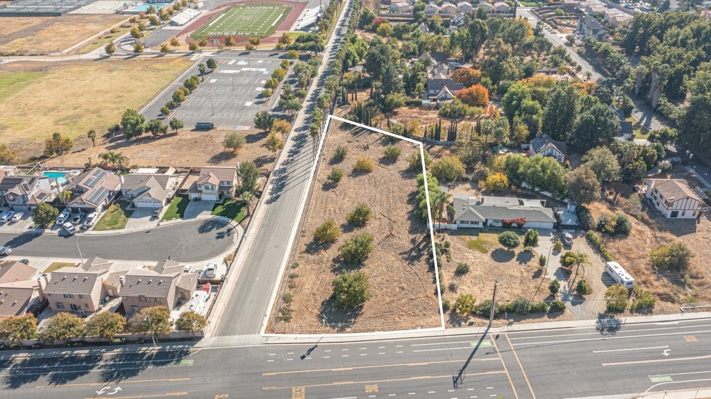 Huge 1.11 acre flat corner lot in the middle of a developed area. Surrounded by beautiful mountains, this would be a fantastic location to build your next home. Water, sewer, and electric are in the street. EVMWD map attached in supplements. Land in located in a low tax zone with no HOA. Streets and sidewalks are already in. Come check out this great lot and buy the lot to build now or hold for a future investment. Great opportunity!!