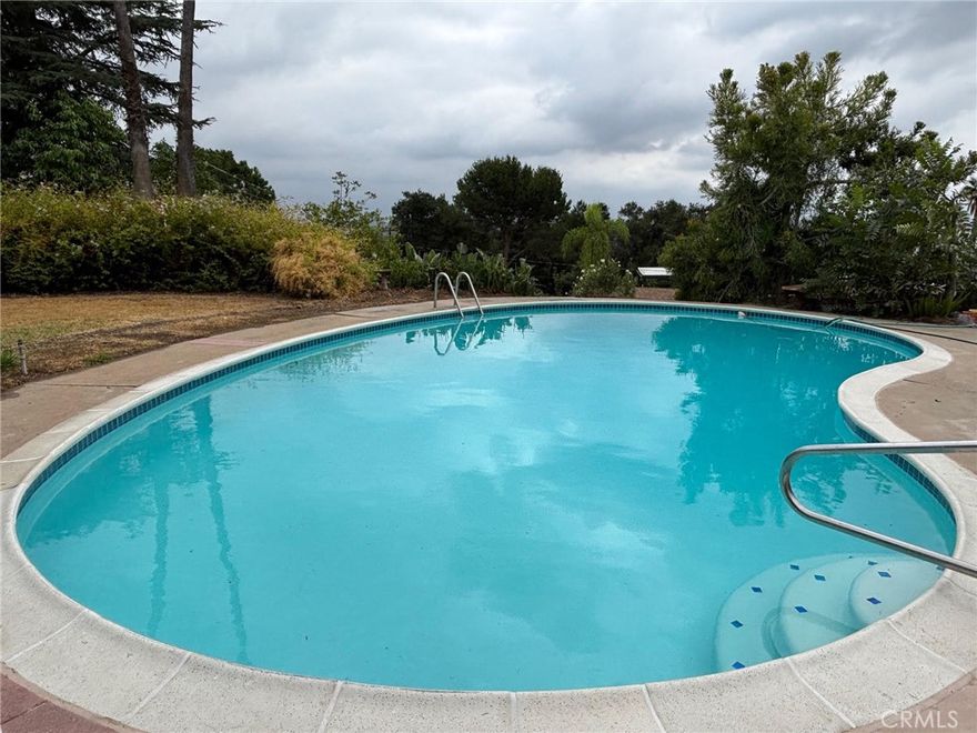 First Time on the Market! Rare Mid-Century Pool Home in Glendora



Offered for the first time in over half a century, this beautiful one-story Mid-Century Modern home boasts over 2,200 sq. ft. of living space and sits on more than an acre of land in the historic Glencoe Heights Ranch. Perched high above Foothill Blvd, the property showcases breathtaking views of the valley, rolling hills, and city lights.



Built in 1958 with distinctive redwood siding, this custom residence is a true architectural gem — a timeless tribute to mid-century design, quality craftsmanship, and the enduring strength of the American dream.



Interior Highlights:



Remodeled kitchen with marble countertops, breakfast bar, Blanco stone sink, stainless steel appliances, and walk-in pantry;



Kitchen opens to a spacious family room with vaulted wood-beam ceilings, new vinyl plank flooring, and a dramatic stone fireplace;



Large primary suite with newly remodeled bathroom featuring a dual-sink vanity, subway tile shower with custom glass walls, and a dressing area with double closets;



Two additional generous-sized bedrooms with new carpet, serviced by a remodeled hall bathroom with upgraded vanity and glass-enclosed tile shower;



Spacious formal living and dining rooms with vaulted wood-beam ceilings, picture windows, and a beautiful gas/wood-burning fireplace;



New vinyl plank flooring throughout entry, hallways, kitchen, and bathrooms;



Outdoor & Additional Features:



Expansive rear patio overlooking the newly remodeled oversized swimming pool and lush lawn — perfect for entertaining!



Large two-story workshop/storage building, ideal for hobbyists, artisans, or additional creative space.



Over an acre of private land offering endless possibilities.



This rare Glendora property combines mid-century modern charm with thoughtful updates, generous living spaces, and unparalleled views.



Come experience this one-of-a-kind home today — an opportunity not to be missed!  See Supplements for Map of Properrty,