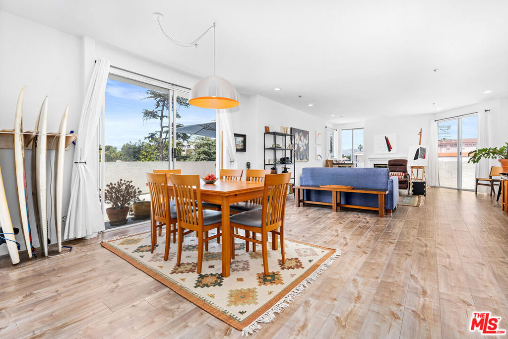 Nestled in the historic Windsor Village of Hancock Park, this top-floor northwest corner residence offers privacy, scale, and sophistication. Steps from Harold A. Henry Park and convenient transit via Wilshire/Western Metro and nearby bus lines, the home is also close to cultural gems like the Ebell Theatre, Marciano Art Museum, and Larchmont Village shops and restaurants. Inside, soaring ceilings and floor-to-ceiling windows fill the space with natural light and showcase views of Fremont Place, Hancock Park, and the Hollywood Hills. The expansive living room features a modern gas fireplace with black fire glass and flows seamlessly to a wraparound deck, perfect for indoor/outdoor living. A second balcony off the dining room offers tree-top views for entertaining. The primary suite is a generous retreat with a walk-in closet, separate tub and shower, and dual lavatories. A secondary bedroom is ideal for guests or a home office. Combining rare scale, privacy, and location, this residence epitomizes luxury condo living moments from Larchmont Village, La Brea Design Quarter, Korea-town, West Hollywood, and Downtown.