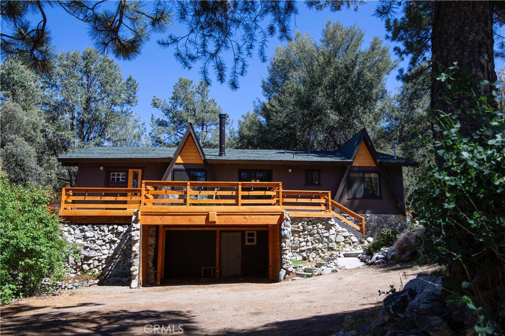 Hidden Gem with Space, Style & Privacy – 1816 Bernina Dr
Tucked away behind mature trees and natural landscaping, this spacious mountain home offers privacy, views, and plenty of room to spread out. A large front yard provides additional parking and a welcoming buffer of space, enhancing both convenience and seclusion. With 5 bedrooms, 3 bathrooms, and multiple living areas, this home is ideal for family living, entertaining, or hosting guests.
Step inside to an impressive living room with a wood-beam cathedral ceiling, warm laminate wood floors, and a wood-burning stove set on an elevated brick hearth. The open floor plan connects the living, dining, and kitchen areas seamlessly, while a separate family room creates the perfect retreat for kids or cozy evenings.
The kitchen blends modern style with timeless charm—featuring stainless steel appliances, a sleek range hood, white Corian countertops, crisp white cabinets, and floating shelves that offer stylish display space.
The oversized primary suite is a true escape with a huge mirrored closet and a spa-inspired bathroom complete with classic wainscoting and a clawfoot soaking tub. Here you’ll also find a second bedroom and an additional ¾ bath—perfect for a home office or guest quarters.
Downstairs offers three more generously sized bedrooms and a full bath with a tile shower/tub combo and tile flooring.
Additional highlights include a 2-car carport, an expansive front yard with extra parking, and the peace of living surrounded by nature.