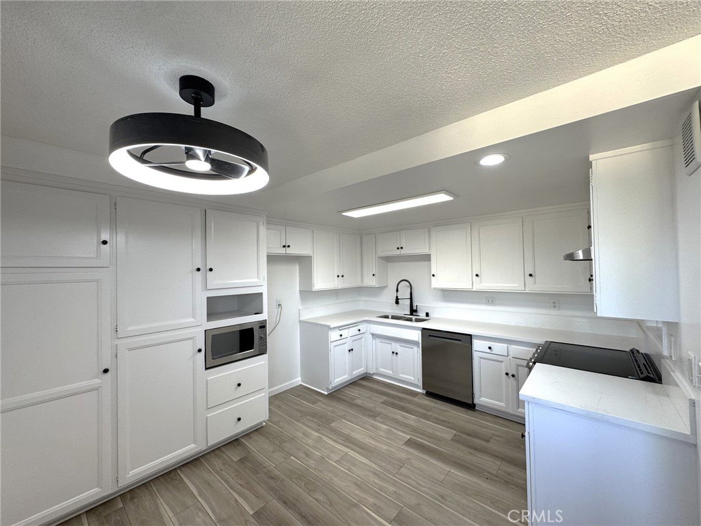 LOW HOA FEES!!! ONLY $ 275!! Welcome to this beautifully renovated 2 bedroom, 1 bath GATED condo in the heart of Gardena! Step inside to find a bright and inviting floor plan featuring new luxury vinyl plank flooring, fresh paint throughout, and abundant natural light. The kitchen has been renovated with all-new appliances, modern fixtures, and a stylish ceiling fan, making it the perfect space to cook and gather. The bathroom offers a sleek, modern feel with an updated vanity and finishes. Both bedrooms are generously sized with large closets for ample storage. Enjoy the outdoors on your spacious private patio, ideal for relaxing or entertaining. Additional highlights include one covered parking space with extra storage, community laundry, and extensive storage options. With its move-in ready condition and thoughtful upgrades, this condo is a true winner—perfect for first-time buyers, downsizers, or investors alike.