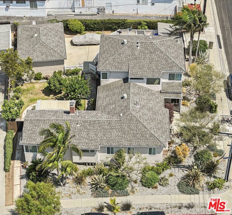**Property was owner occupied and meticulously cared and maintained by the family for over two decades** First time on the market in nearly 30 years, 5931-5935 W 79th Street is a 2,589 sq. ft. one-of-a-kind building set on a 9,019 sq. ft. corner lot in Westchester's desirable Westport Heights neighborhood. Located in a quiet, residential pocket near Loyola Marymount University, LAX, Otis College of Art, and close to Silicon Beach, SoFi Stadium, and nearby beach towns like Marina del Rey, Playa del Rey, and Manhattan Beach, this property offers both a prime location and significant long-term potential.The building features a vacant 2-bedroom/2-bathroom front house with a den and a private backyard, and two 2-bedroom/1-bath units. The den is privately sectioned off and has been remodeled with vaulted ceilings, vinyl flooring and a stone fireplace, making it perfect for a savvy owner occupier looking to generate more income through home sharing. Additional features include three garages (2 vacant), 4 parking spaces, a shed, and ample street parking making it ideal for multigenerational living, an owner-occupant, student, or creative professional.Recent upgrades include new water heaters installed in 2025, original hardwood floors and luxury vinyl flooring with oversized baseboards. The property also retains its original crown molding and has updated bathrooms, double pane windows, new electrical panels and new ABS sewage piping. The deck was replaced last year with Trex materials, and the entire building was repainted with Tex-Cote. The fully gated, oversized lot is surrounded by lush gardens, a low-scape yard with low water tolerant plants, an irrigation system, and a collection of mature exotic trees including Indian curry leaf, Thai kaffir lime, Vietnamese pomelo, avocado, palo verde, crape myrtle, and Japanese maple.This property is a fantastic option for an owner-occupant looking to live in one unit and rent out the others. With today's rate buy-down programs, buyers may qualify for financing as low as 5.625%. Moreover, this turnkey, low-maintenance property offers tremendous upside: with the recent passage of SB1211, buyers can now build up to three additional units on the lot without needing to remove existing parking.