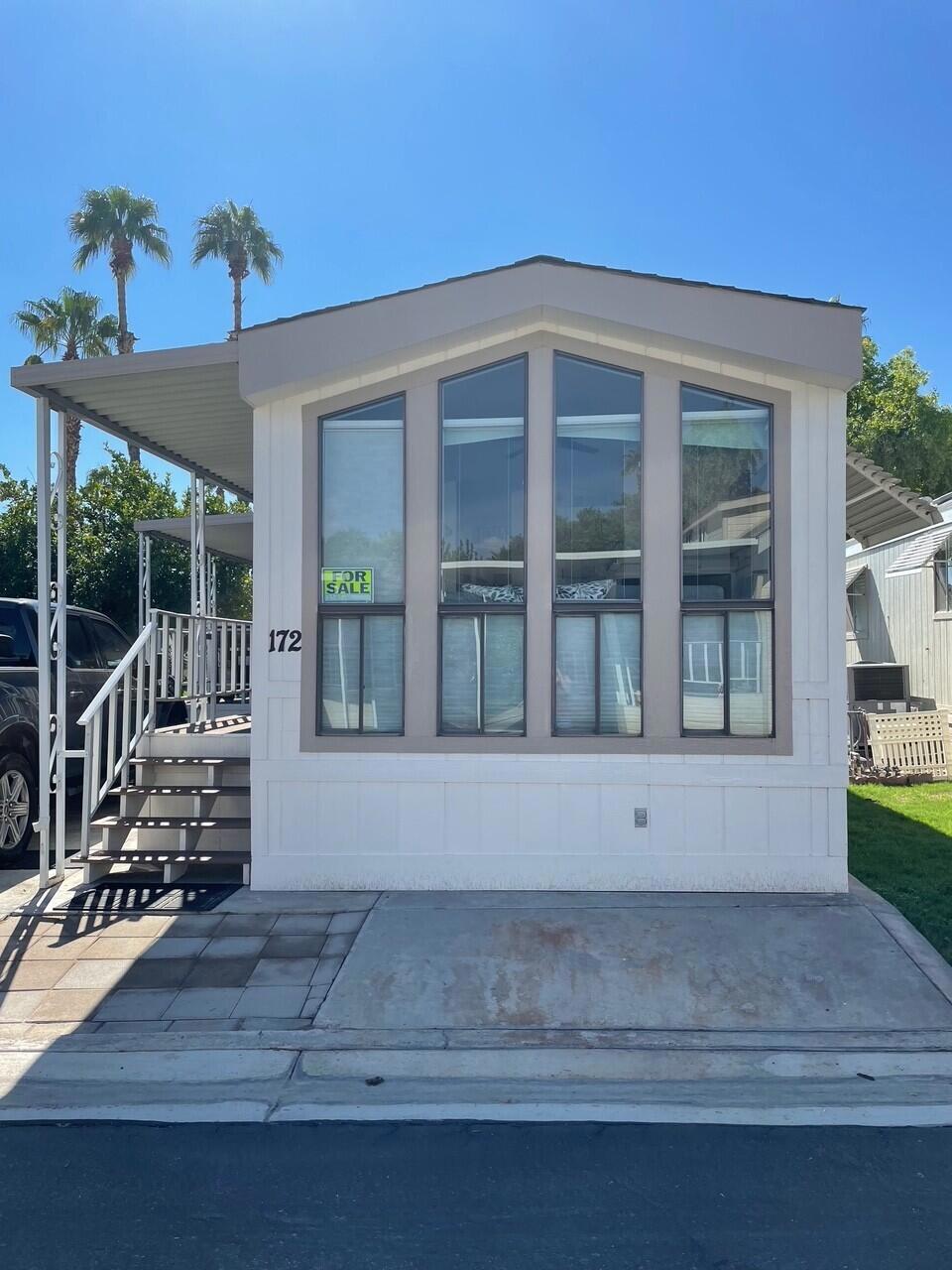 Quiet Location with Green Belt behind. Remodeled a few years ago with covered outside deck. Very Open to Living Area with Laminate Flooring, White Cabinetry and White Appliances including Microwave above stove. Mirrored Closet Doors in Bedroom. Washer/Dryer are in the Shed.
