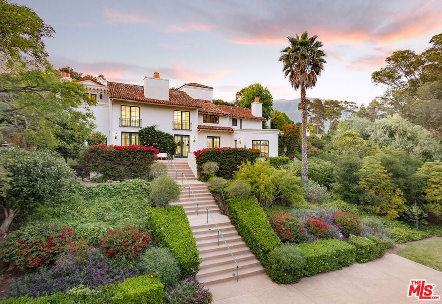Tucked behind the gates of Montecito's coveted Ennisbrook community, 284 Gould Lane is a grand Mediterranean residence blending timeless architecture with privacy and scale. Set amid vibrant gardens on 1.68 acres, this expansive estate captures the romance of Santa Barbara's golden age with its classic clay tile roof and wrought iron detailing. A dramatic formal entry introduces the voluminous interiors, where a soaring great room with a stone fireplace and oversized windows offers an elegant focal point for gathering. Just beyond, the formal dining room opens to a sun-drenched terrace, ideal for indoor-outdoor entertaining.The spacious kitchen includes a charming breakfast nook and bar seating, with windows that overlook the beautiful pool and spa, creating a serene backdrop for everyday living. The bedrooms provide generous accommodations, including a primary suite with fireplace, sitting area, and peaceful views. A separate guest suite above the garage, complete with its own entrance and full bath, offers added privacy for visitors or extended stays. Multiple living spaces - including an office and cozy den with a fireplace and a flexible upstairs landing - ensure room for both relaxation and entertaining. Outside, meandering paths wind through colorful plantings, mature trees, and blooming bougainvillea. Multiple patios offer peaceful settings for al fresco dining, while the motor court and three-car garage provide ample parking and storage. Located within the highly desired Ennisbrook enclave, this residence enjoys access to community amenities including tennis courts, pool, clubhouse, scenic trails, and security. An exceptional opportunity to experience the Montecito lifestyle in a gated setting just moments from beaches, shops, and the Upper & Lower Village.