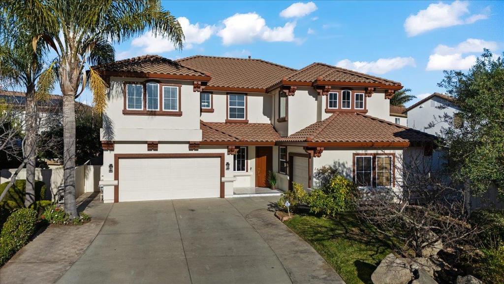 Welcome to this exceptional 6-bedroom, 3-bath residence, showcasing superior craftsmanship and extensive upgrades throughout. Designed with elegance and functionality in mind, this home features crown molding, travertine tile, wood floors and carpeting, blending timeless design with modern comfort. At the heart of the home is a spacious, open-concept kitchen, perfectly suited for both everyday living and refined entertaining. Flow effortlessly into the family and dining areas, where natural light fills the space to create a warm, inviting atmosphere. A bedroom conveniently located downstairs offers flexibility for guests, extended family, or a private office ideal for todays lifestyle needs. Step outside to a large, beautifully landscaped backyard featuring grass and elegant stamped-cement patios perfect for relaxing, entertaining, or hosting gatherings in style. Nestled on a quiet cul-de-sac, this home offers peace, privacy, and prestige, while remaining close to shopping centers, restaurants, and freeway access. The tile roof and stunning elevation enhance its curb appeal, reflecting the timeless quality of its design. Built by the highly respected Herod Homes, this is one of the largest and most desirable models in the community.