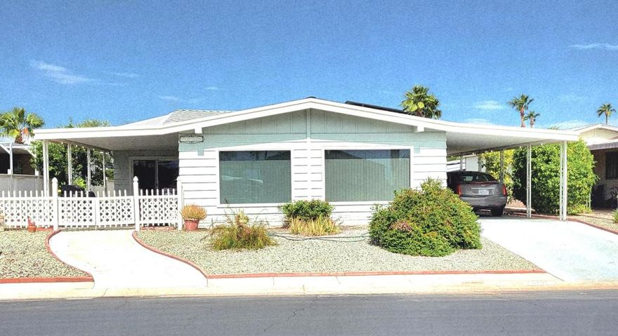 This spacious 2-bedroom, 2- bath residence is situated on a sought-after interior street and features large dual-pane windows with vertical blinds, ensuring abundant natural light and view of the mountains. Significant enhancements have been professionally completed to improve energy efficiency, including new heating and air conditioning, ceiling fans, a new roof, and solar system. The solar lease can be easily transferred to buyer. Newer carpeting in the living room, dining area, and bedrooms provides added elegance and comfort. Well-appointed kitchen  affords convenient access to both the formal dining room and a generously sized family room/den, presenting an excellent venue for entertainment. The primary suite offers double closets, while the en-suite bath features a large soaking tub, dual sinks and walk-in shower; the guest bathroom has been updated. This well-maintained home is move-in ready for new owners. Residents of Palm Desert Greens benefit from proximity to shopping, dining, casinos, and medical facilities. A low monthly fee of $400 includes complimentary golf, 24/7 guard-gated security, cable television, Wi-Fi, trash removal, an on-site restaurant and bar, and numerous other amenities. Please contact us to schedule a private tour of this exceptional home.