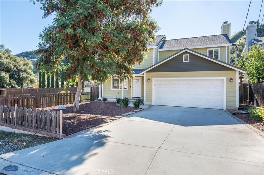 Welcome to this gorgeous 3-bedroom, 2.5-bathroom home built in 2015, perfectly situated in the heart of Val Verde and just a short walk to the local park where year-round family events are enjoyed. Featuring beautiful curb appeal with fresh wood chips and updated landscaping, this home instantly feels warm and inviting. Step inside to discover stunning wood flooring that flows through the dining room and living room, creating a seamless open-concept layout ideal for entertaining. The kitchen opens beautifully to both spaces and features tile flooring, granite countertops, stainless steel appliances- including a wine refrigerator- recessed lighting, and rich cabinetry with crown moulding. A convenient downstairs half bathroom is perfect for guests. The spacious living room offers a cozy gas fireplace, ceiling fan, and sliding glass door leading to the backyard. Outside, you’ll find a large grassy area, a separate concrete pad, and a charming gazebo—perfect for relaxing, BBQs, or outdoor gatherings. Upstairs, wood flooring continues throughout, with tile flooring in both bathrooms. The extra-large primary suite includes a ceiling fan, walk-in closet, black-out curtains, and an en-suite bathroom with dual sinks, extra storage, and a beautifully tiled shower area. Both secondary bedrooms are light and bright with multiple windows, ceiling fans, and walk-in closets. Additional highlights include no HOA, no Mello Roos, and proximity to the 126 for easy commuting. This home is also conveniently located near a county park and pool, making outdoor recreation effortless. Don’t miss this incredible opportunity to own a beautifully updated home in a wonderful location!