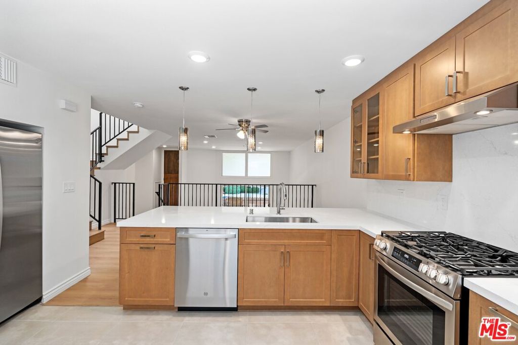 Experience modern living in this fully renovated 3BR/2.5BA townhouse in the heart of Encino! This spacious 1,600 sq ft home features brand-new HVAC, water heater, and stainless steel appliances including fridge, stove, range, and dishwasher. Step into an expansive living room with high ceilings and recessed lighting, flowing into a formal dining area with elegant wrought iron railings. The updated kitchen boasts sleek cabinetry, quartz countertops, and contemporary finishes. All bedrooms are upstairs, including a generous primary suite with a walk-in closet and dual vanities. Enjoy laminate wood-style flooring throughout, tile in the kitchen and baths, a large private patio, and a 2-car attached garage. Prime location just moments from Ventura Blvd, Ralphs, Trader Joe's, Target, Starbucks, and top-tier dining and shopping.