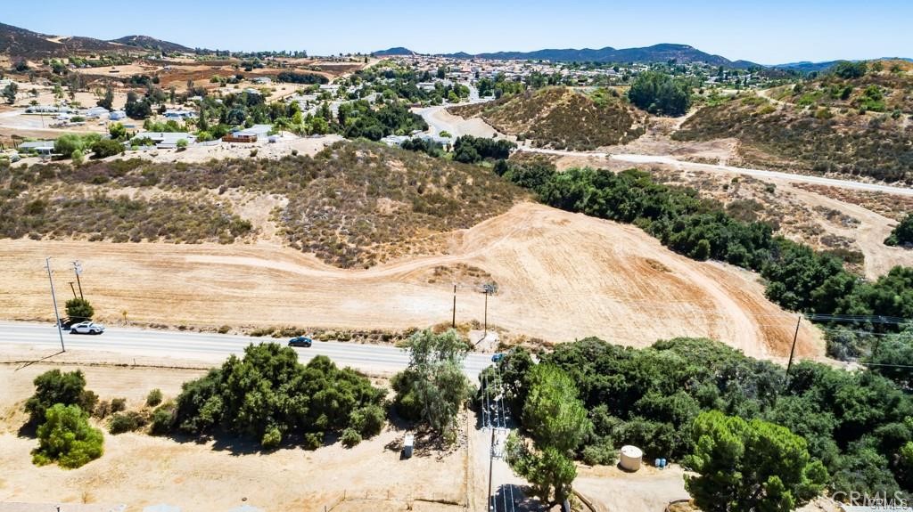 READY to GO! FOUR (4) contiguous flat lots, approximately 3/4 of an acre of usable land! The seller has done most of the upfront footwork & expense to make this land "Ready to Build"! Active Working Well ($25k to $30k value included), Very recent percolation test ($4,500 value included) Land Survey with site plan that shows elevations ($4,000 value included) Electric available very close by! This is your opportunity to build a home or bring in a manufactured home with a huge head start! Located just North of Bundy Canyon in between the 15 & 215 freeways it is close to major new developments, excellent schools, shopping, restaurants & parks! This land is right in the line of future Menifee progress! Great opportunity to invest in your future dream home or build & sell, lots of upside! Drive by today, these wonderful lots will not last long! Property is North of Bundy, enter on Cottonwood heading North, dirt road that may be paved at some point in the future, the lots are at the Northeast corner of Olive & Spruce. Drive by anytime!