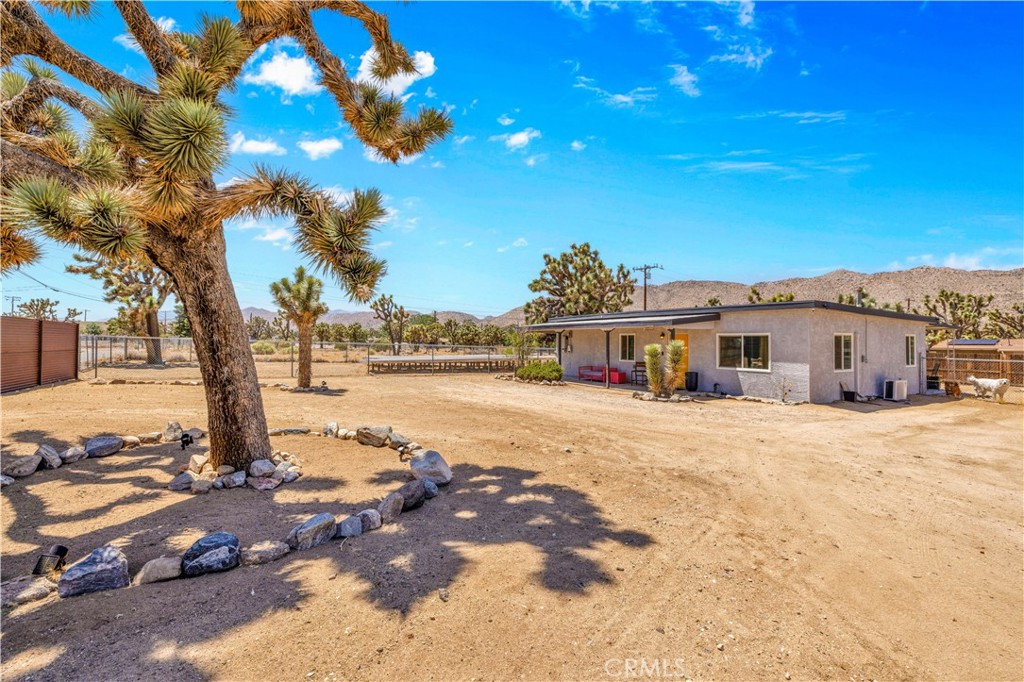 Updated 2 Bed + Bonus Room on Over Half an Acre in Yucca Valley with PAID SOLAR! Welcome to this charming and newly updated 2-bedroom, 1-bath home with a bonus room, offering 1,120 square feet of living space on a fully fenced 0.54-acre lot in beautiful Yucca Valley. Step inside to find luxury vinyl plank flooring throughout, a completely remodeled kitchen with new cabinets, countertops, and appliances, and an open-concept layout connecting the kitchen, dining, and living areas—perfect for everyday living and entertaining. The mini-split system in the living room ensures comfort year-round. The updated bathroom features a stylish tile shower/tub combo, and the bonus room offers flexibility—ideal for a home office or guest space. Outside, enjoy a covered front porch, covered back patio with sweeping views of the northern mountains, and plenty of space for parking thanks to the circular driveway. There’s also a new backyard Tuff shed for additional storage. The property features a completely paid solar system that is on the ground and fully fenced which makes maintenance a breeze. With its great location, modern updates, and spacious lot, this home is a fantastic opportunity—whether you’re looking for a primary residence, a desert getaway, or a long-term investment. Call today to schedule your private tour!