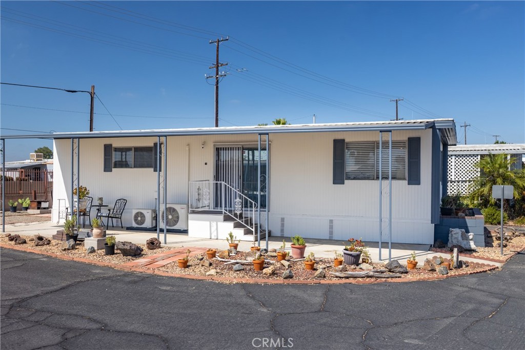 Corner lot home in gated Eden Roc Villas South 55+ senior park. Spacious living room w/fireplace & dining area w/built-in hutch. Light & bright kitchen has dishwasher, stainless steel refrigerator & microwave. Laundry area at the end & newer washer/dryer are included. Good-sized closets in both bedrooms. Newer tub/shower enclosure & toilet in the bathroom. Home has central heat, and two newer wall-mounted mini-split AC units to keep you cool in the summer. Exterior recently painted. Side patio is covered, and there is a nice sitting area behind the home too. Storage shed at the end of the carport. Active community has amenities that include clubhouse, pool, indoor spa, billiards room, and many social activities & get togethers scheduled each month. Located close to shopping & restaurants.