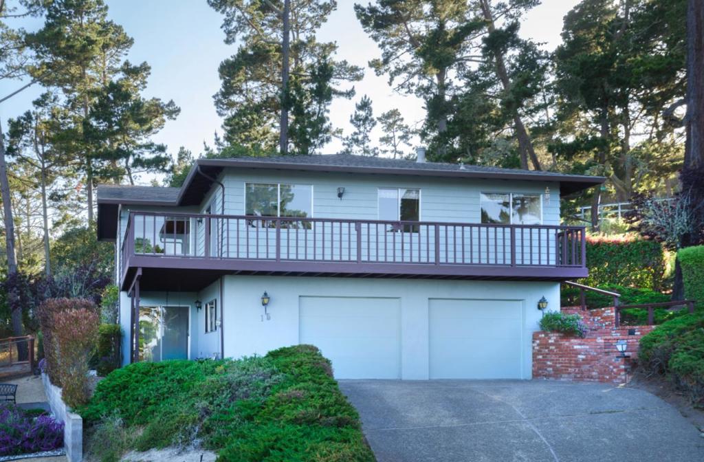 Welcome to Pinehill, a spacious and light-filled 3-bed, 3 bath home on a .23-acre lot in Monterey's coveted Skyline Forest, offering beautiful Monterey Bay ocean views and exceptional potential for thoughtful transformation. Elevated on a generous lot at the end of a quiet cul-de-sac, this reverse floor plan residence is designed to embrace its tranquil coastal setting. The main level features vaulted ceilings and expansive windows that frame captivating ocean views. The dining area opens to a wraparound deck perfect for morning coffee and amazing sunsets. A primary suite with an ensuite bath and private balcony, a second bedroom, and a hall bath complete the main level. Downstairs, a bright family room with a wet bar, a third bedroom, a full bath, plenty of storage, and a two-car garage with laundry. Flexibility for guests or extended stays. This home offers a strong foundation for customization, abundant natural light, and an unbeatable location. Pinehill presents a rare opportunity to craft a personalized retreat in one of California's most desirable coastal communities.