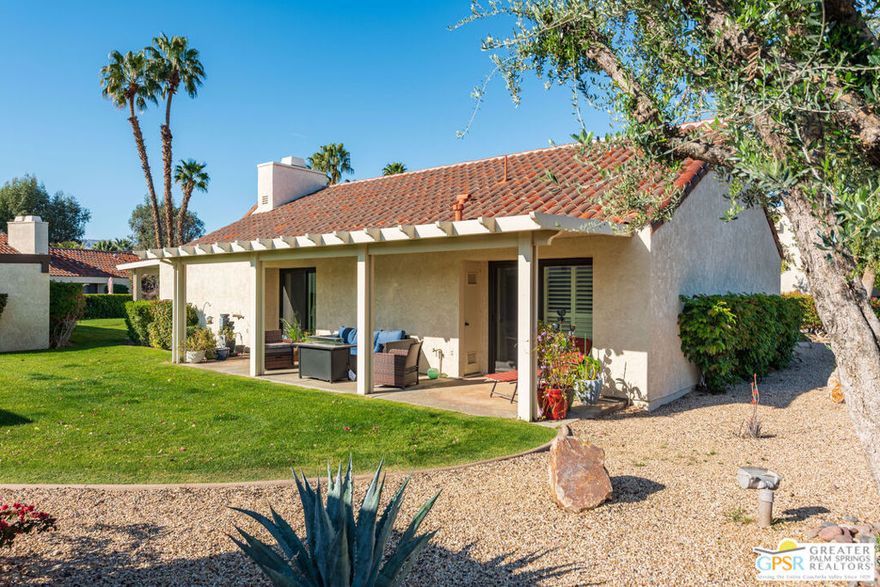 REDUCED - Experience the ultimate country club lifestyle in this beautifully upgraded, turnkey furnished, one-bedroom end-unit condo within the prestigious Mission Hills Country Club. Situated in a quiet location, just steps from community pools, this residence offers exceptional privacy and two inviting covered patios, complete with pergolas and a tranquil water feature, perfect for entertaining and relaxation. Inside, discover a light and airy open floor plan featuring vaulted beamed ceilings, creating a warm and spacious ambiance. Recent renovations include new flooring, stainless steel appliances, double-pane sliding doors and windows, custom plantation shutters throughout, upgraded lighting, a stylish fireplace tile surround, and a luxurious walk-in shower. A high-capacity washer/dryer adds to the convenience. The well-appointed kitchen seamlessly flows into the great room, ideal for open-concept living. This condo is perfect as a vacation retreat, permanent residence, or 30-day+ rental. A large, detached two-car garage, located just steps away, provides ample storage.Mission Hills Country Club, a guard-gated community in desirable Rancho Mirage, is renowned for its rich history and world-class amenities. Members enjoy access to three championship golf courses, 30 tennis courts (grass, clay, and hard), pickleball courts, croquet, a state-of-the-art fitness center, spa services, and multiple dining and social venues. Located minutes from Palm Springs International Airport, El Paseo shopping, and major entertainment, this is your opportunity to embrace the coveted Mission Hills lifestyle.