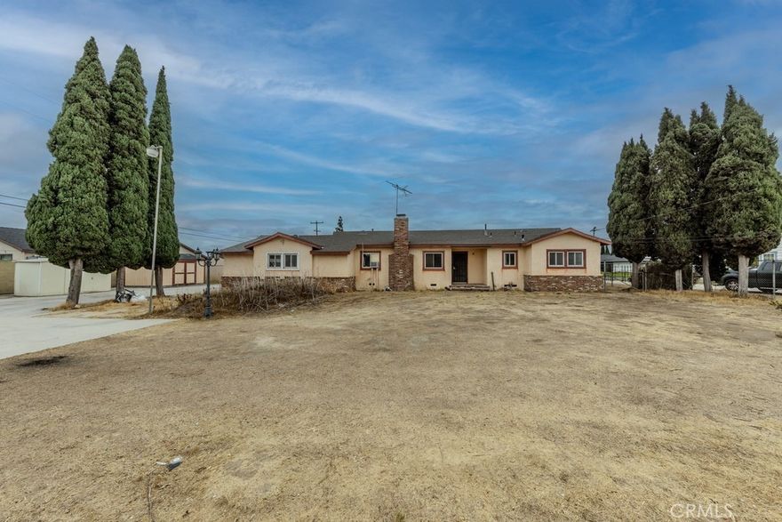 Single-story home on an oversized double lot with rare driveway access directly from Orangethorpe Avenue. Located at 18511 Orangethorpe Avenue in Anaheim, this three-bedroom, two-bath residence offers 1,366 square feet of living space on a 15,882-square-foot parcel. Originally, the first home built in this tract, when the area was covered by orange groves, retained its unique orientation and land use potential.



The entry opens to a living room with a fireplace on the left, while the family room sits straight ahead and connects to the kitchen. A hallway to the right leads to the bedroom wing, where a full bath serves all three bedrooms. A separate half bath is positioned at the opposite end of the home near the interior access to the attached two-car garage. The family room also opens directly to the rear yard.



The home is a fixer and requires renovation, but includes key improvements such as copper plumbing, an added sewer line, and updates to the windows and roof.



The oversized lot provides extensive parking and storage with space for RVs, trailers, or multiple vehicles. The double-lot orientation offers flexibility for future use, whether additional structures or expanded outdoor living.



The property is located within a residential neighborhood that developed around it and offers close proximity to shopping, dining, and major freeways for regional commuting. The home is served by the Placentia-Yorba Linda Unified School District, with nearby schools including Glenview Elementary, Bernardo Yorba Middle, and Esperanza High.



This is a rare opportunity to purchase one of the earliest homes in the area, with nearly 16,000 square feet of flat land and a layout well-suited for both current use and long-term improvement.