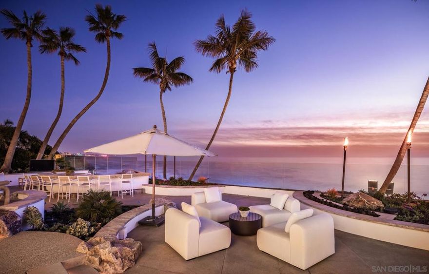 Recently renovated & situated atop a magical 1.5 acre oceanfront lot spanning two parcels with 165 feet of prime Southern California coastline featuring panoramic views of the Pacific Ocean with private stairs to the sand, this turn-key paradise is truly unlike anything else. This estate has been tastefully renovated showcasing a light, bright modern feel throughout. The main residence offers 4 spacious en-suite bedrooms with 2 bedrooms on the entry level & 2 bedrooms upstairs (secondary primary suite on entry level), ocean view office, movie theater, billiards room, ocean view laundry room & 3 car garage with lots of storage. The property also offers a detached 1 bedroom/2 bathroom guest house with family room. With multiple decks & beautiful outdoor loggia spaces overlooking the beach, there is no better place to watch the surfers catch waves & stunning sunsets. Privately gated, this exceptional residence offers a dramatic entry with one-of-a-kind water feature with fire & massive motor court. Properties like this are rare - do not miss the opportunity to own the coastal jewel of San Diego.