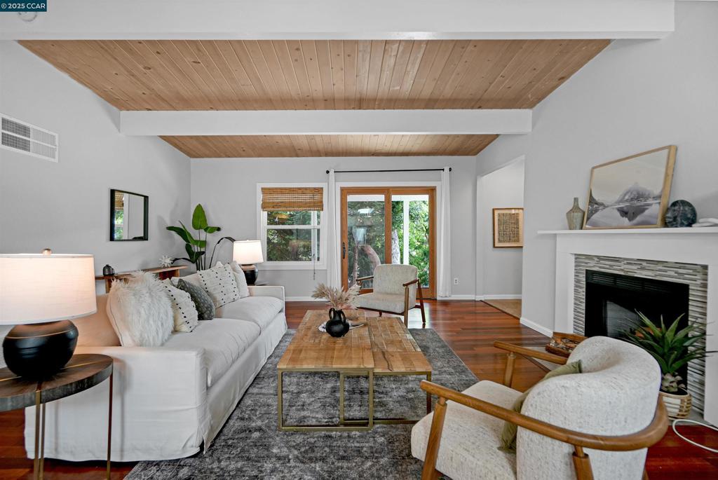 Welcome to this private 3-bed, 2-bath El Sobrante retreat on an oversized 11,000+ sq ft lot. Freshly painted interiors, dual-pane windows, hardwood floors, and stylish lighting create a warm, refreshed feel. The open layout flows from the living room with fireplace and large windows, into a dining area and beautifully updated kitchen with white shaker cabinetry, quartz counters, stainless steel appliances, and counter seating—perfect for everyday living or entertaining. Two bedrooms and a spacious bath are downstairs, while the upstairs primary suite offers a spa-inspired bath and French doors leading to a balcony deck with hillside views. Outdoors, enjoy mature landscaping, trees, and ample space for relaxing, storage, or projects. A large garage, extended driveway, and street parking add convenience. Ideally located near schools, parks, a reservoir, trails, shopping, and BART with easy access to freeways. Meticulously maintained, this move-in ready home blends comfort, functionality, and lifestyle—don’t miss it!