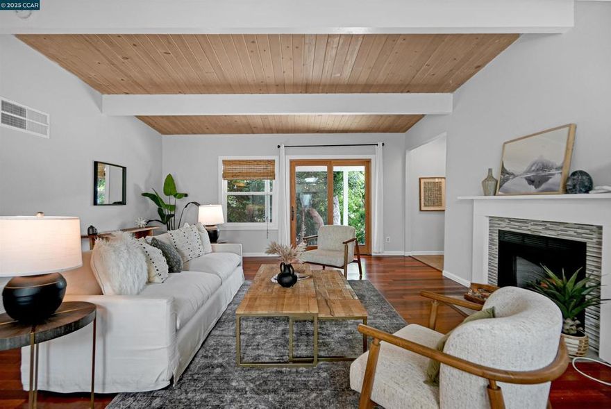 Welcome to this private 3-bed, 2-bath El Sobrante retreat on an oversized 11,000+ sq ft lot. Freshly painted interiors, dual-pane windows, hardwood floors, and stylish lighting create a warm, refreshed feel. The open layout flows from the living room with fireplace and large windows, into a dining area and beautifully updated kitchen with white shaker cabinetry, quartz counters, stainless steel appliances, and counter seating—perfect for everyday living or entertaining. Two bedrooms and a spacious bath are downstairs, while the upstairs primary suite offers a spa-inspired bath and French doors leading to a balcony deck with hillside views. Outdoors, enjoy mature landscaping, trees, and ample space for relaxing, storage, or projects. A large garage, extended driveway, and street parking add convenience. Ideally located near schools, parks, a reservoir, trails, shopping, and BART with easy access to freeways. Meticulously maintained, this move-in ready home blends comfort, functionality, and lifestyle—don’t miss it!