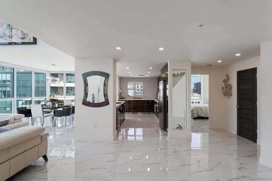 This stunning urban penthouse redefines luxury with over 2,000 sq. ft. of impeccably designed living space across two stories. Boasting 3 spacious bedrooms, this residence is an architectural masterpiece. At its heart, a striking curved staircase serves as both a functional centerpiece and an artful statement.  Floor-to-ceiling glass floods the space with natural light, showcasing breathtaking city views from every angle. The expansive living room features a dramatic open-to-below design, perfect for both relaxation and entertaining. Gleaming marble floors throughout add a touch of timeless elegance, complementing the sleek, remodeled kitchen equipped with top-of-the-line appliances, custom cabinetry, and exquisite finishes.  This penthouse harmonizes sophistication with comfort, offering a lifestyle of unparalleled urban luxury. Nestled in the heart of San Diego’s prestigious Marina District, this iconic dual-tower high-rise embodies modern luxury and resort-style living. Perfectly positioned, it offers unparalleled access to the city’s finest dining, shopping, and entertainment, with the sparkling waterfront just steps away. Residents enjoy the convenience of being minutes from Seaport Village, the Gaslamp Quarter, and some of the city’s most scenic parks and marinas.  The building itself is a masterpiece of contemporary design, blending sophistication with function. A guard-gated entrance ensures privacy and security, providing peace of mind for all residents. Upon arrival, guests and homeowners are greeted by not one, but two opulent lobbies, each meticulously designed to evoke a sense of exclusivity and refinement. Soaring ceilings, designer lighting, and elegant finishes create a welcoming ambiance that sets the tone for the rest of the property.  Amenities abound, offering a lifestyle that rivals a five-star resort. A shimmering outdoor pool and adjoining spa are perfect for soaking up the San Diego sunshine, while water features throughout the grounds add an element of tranquility. Fitness enthusiasts will appreciate the state-of-the-art gym, complete with top-tier equipment, a dedicated yoga area, and both wet and dry saunas for post-workout relaxation.  For those who love to entertain, the building boasts ample guest parking spaces, making it easy to host friends and family. Residents can also take advantage of community lounges and meeting spaces, ideal for both social gatherings and business needs. Lush landscaping surrounds the property, creating a serene oasis in the heart of the city, with courtyards and outdoor seating areas providing quiet escapes.  With its prime Marina District location and an array of high-end amenities, this building delivers an unrivaled living experience. Whether you’re savoring the views from your penthouse or enjoying the vibrant culture of downtown San Diego, life here is nothing short of​​‌​​​​‌​​‌‌​​‌​​​‌‌​​​‌​​‌‌​​​‌​‌​​​‌‌​ extraordinary.