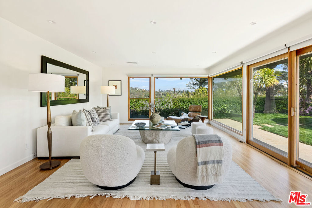 Set back from the street on a flat section of Westridge, this beautifully renovated single-story home seamlessly blends modern style with casual comfort. Upon entering through the gated courtyard, you're welcomed by a lush, expansive yard featuring new sod, a vegetable garden, and an elevated wooden deck. Large windows and French doors bathe the home in natural light, creating a bright and inviting atmosphere. The stunning kitchen flows effortlessly into the dining and living areas, where wood floors, a charming white-beamed ceiling, and a cozy fireplace add warmth and character. The spacious primary suite opens to a private, peaceful backyard with mountain views and features a remodeled bathroom. Generously sized guest bedrooms are complemented by tastefully updated bathrooms. The detached garage has been thoughtfully transformed into a stylish studio, complete with office space, bathroom and a private patio. The newly landscaped grounds enhance the home's privacy, making this an exceptional property, perfect for both relaxation and entertaining.