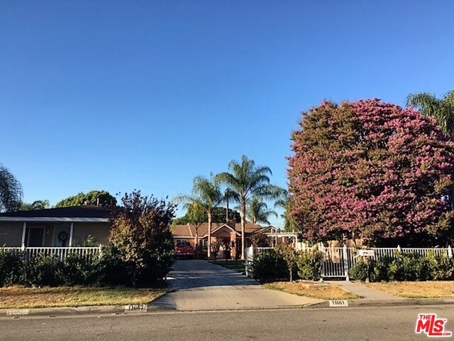 Fabulous well maintained 2 separate homes in El Monte. Property sits on 13,869 sq. ft lot. Front (11657) house has 2 bedrooms and 1 bath with beautiful ceramic tiles throughout. Rear house (11661) has 3 bedrooms with master suite and 2 baths plus a powder room and a living room with fireplace. Both houses have open concept upgraded kitchen with granite counter tops, updated bathrooms, central air/heat, recessed lighting, blue copper plumbing, updated electrical panels, double pane windows and each house has it's own separate laundry room. Plenty of parking including a carport and a built in BBQ. Garage has been converted to an office but not permitted. Beautiful front yard with grassy area, lush plantings and mature trees.