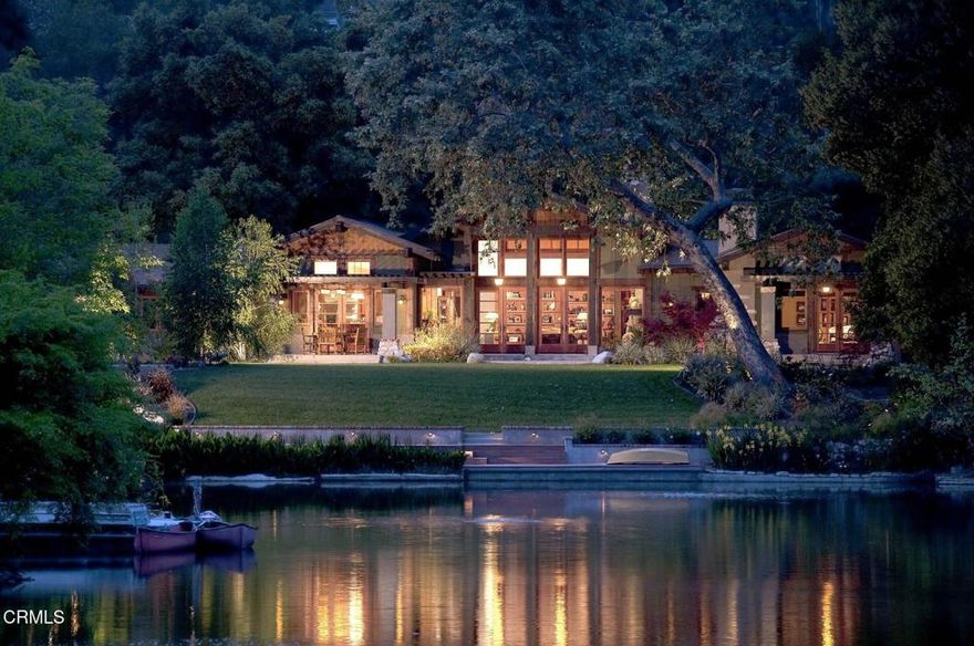 Nestled along the tranquil shores of Johnston Lake in Pasadena's prestigious south San Rafael neighborhood, this exceptional Craftsman estate, designed by noted architect Doug Ewing, is a rare architectural statement set amid nature's splendor. The home enjoys a magical over half-acre setting framed by towering oaks & graceful sycamores. Its secluded appeal is enhanced by a private dock and separate guest house. Designed to harmonize with its environment, the residence embraces the lake and landscape from every angle. The dramatic great room, crowned by 18 ft. wood beamed ceilings & anchored by a massive boulder fireplace. Woodwork, crafted by the artsian who restored the iconic Gamble House, reflects Pasadena's most storied traditons. Everywhere there is detail, intention and artistry. Opening through expansive doors to a full patio with sweeping and glittering lake views, the space is flooded with natural light. Designed for entertaining, the open floorplan flows into the eating areas offering opportunities for hosting large parties, private affairs or a wonderful family lifestyle. The kitchen is masterfully designed with a wonderful layout for the serious cook. The informal dining area opens onto a covered patio with a full lake view. The formal dining room exudes elegance.The primary suite is set apart for privacy, featuring a spa-like bath with jetted soaking tub, dual sinks & shower. The retreat area has a romantic fireplace and French doors opening to a peaceful patio that captures the serenity of the beautiful setting. On a separate wing, there are three additonal ensuite bedroom suites.  Coupled with a separate den, featuring a fireplace and access to a front terrace, the home provides inviting spaces for work and relaxation. Across a beautiful lawn is a separate guest house with its own kitchen and bath. Tucked away under a tree canopy with a backdrop of the ever changing scenes on the lake, tt offers a private santuary and a peaceful retreat for guests. A meandering walkway leads over a little bridge to the grassy area know as ' The Meadow' and the HOA pool. This home is a legacy. It stands as a testament to Pasadena's architectural heritage, the artistry of Doug Ewing and the vision of a family who dared to dream of creating this special place on the shores of a hidden lake.