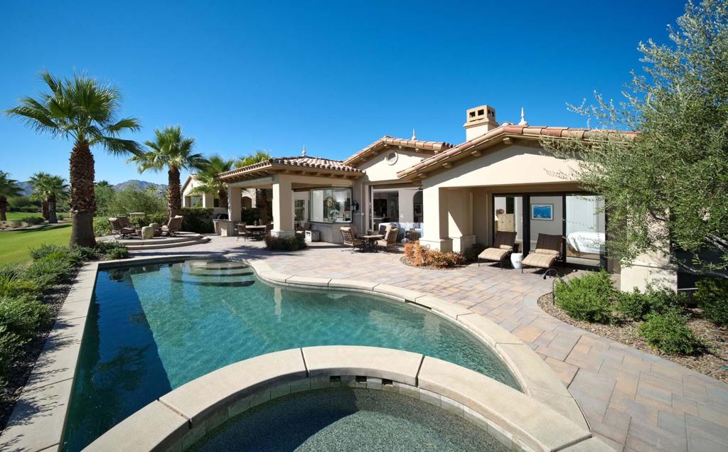 Situated along the 10th fairway of Toscana's North Course, this beautifully appointed Italianate-style home offers sweeping, unobstructed views of the golf course and surrounding mountains--with not another home in sight. Designed for elegant desert living, the residence blends classic European architecture with modern sophistication.The expansive great room features soaring ceilings, a stone fireplace, and dual Fleetwood pocket sliders that seamlessly connect the interior to the outdoor living spaces, filling the home with natural light and showcasing the picturesque landscape. At the heart of the home, the gourmet kitchen is equipped with Sub-Zero and Wolf appliances, custom cabinetry, and ample counter space. A convenient breakfast bar provides the perfect spot for casual dining or morning coffee. The primary suite offers a tranquil retreat with sweeping golf course views and direct patio access. The en-suite bath features a spacious walk-in shower, dual vanities, and a large walk-in closet, creating an atmosphere of refined comfort. A private guest suite, a dedicated office, and a detached casita with its own en-suite bath provide flexible space for hosting family and friends. Outside, the expansive patio invites alfresco entertaining with a built-in BBQ and multiple lounging areas surrounded by lush landscaping. Additional features include a mini split-cooled garage, ideal for climate-controlled storage or hobbies. This exceptional home is a true retreat--where timeless elegance meets the best of desert living in the heart of Toscana Country Club.
