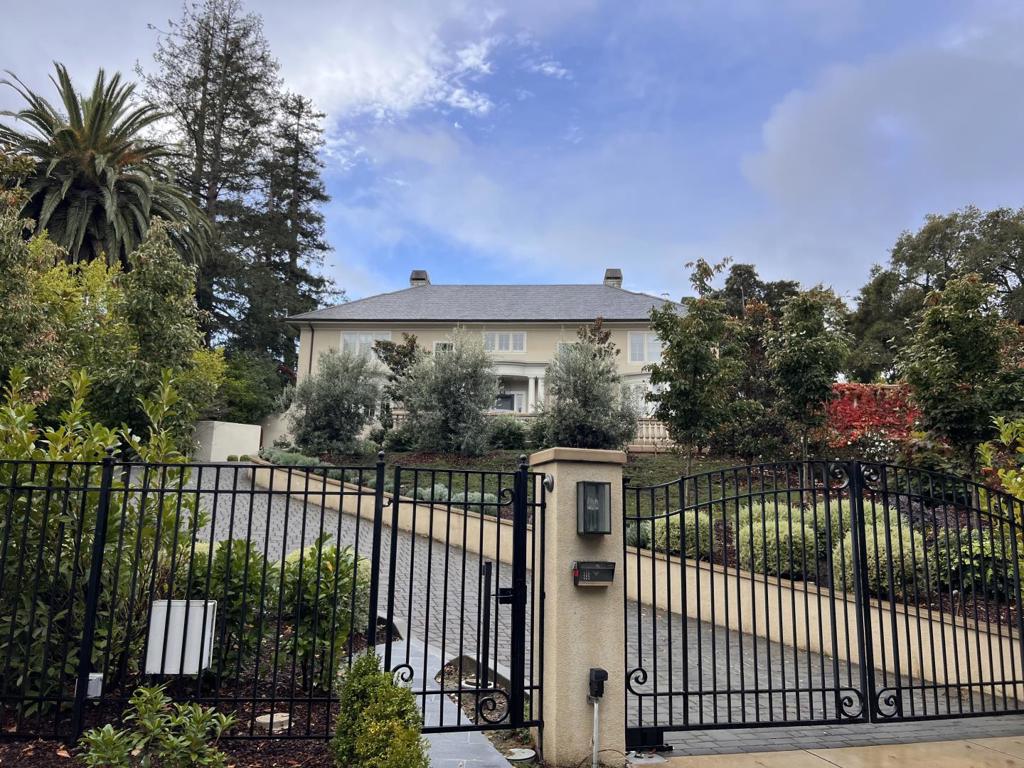 Welcome to this stunning 4-bedroom, 3.5-bathroom home located in the heart of Hillsborough. Spanning 4200 sq ft, this residence offers a blend of elegance and comfort. The kitchen is a chef's dream, equipped with a gas cooktop, marble countertops, built-in ovens, refrigerator, wine refrigerator, and more. The home features carpet and hardwood flooring throughout, enhancing its warm and inviting ambiance. The family room, complete with a separate space, and the formal dining room are perfect for hosting gatherings. Enjoy cozy evenings by the fireplace, and convenience with an upper-floor laundry room featuring a washer, dryer, and tub/sink. The primary suite includes 2 walk-in closets as well as a sports closet and an oversized tub, providing a private retreat. Additional amenities include a bay windows, garden window, high ceilings, security gate, video/audio system, wet bar, and more. The property also boasts a gunite pool and spa/hot tub, perfect for relaxation. Situated in the Hillsborough City Elementary School District, this home is ideal for those seeking a blend of luxury and practicality.