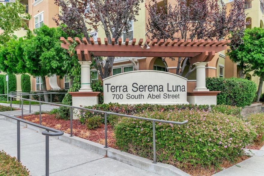 Welcome to this beautifully maintained 2BD/2BA condo in the gated Terra Serena Luna community. This bright and spacious unit offers 1,108 sq ft of open-concept living with modern upgrades throughout. The kitchen features granite countertops, extended bar seating, stainless steel appliances, and a brand new range/oven. Enjoy brand new recessed lighting, updated bathroom fixtures, hardwood floors in the living/dining areas, and newer carpet in bedrooms. Additional highlights include tile flooring in the entry/kitchen, in-unit laundry (Whirlpool W/D), central HVAC, and a private balcony overlooking a peaceful courtyard. Community amenities include a pool, fitness center, clubhouse, BBQ area, playground, EV charging, and two assigned garage parking spaces near the elevator, plus ample guest parking. Prime location near major tech employers, The Great Mall, HWY 680/880/237, and top-rated Milpitas schools: Pearl Zanker Elementary, Rancho Milpitas Middle, and Milpitas High. Move-in ready!