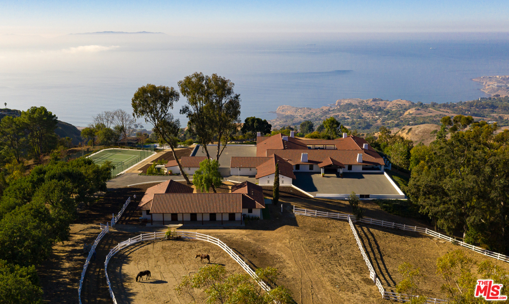 The Hacienda del Prado compound spans 10+ acres of panoramic ocean and Catalina Island views. The property is perched atop the Palos Verdes Peninsula in Rolling Hills, one of greater Los Angeles' most exclusive, guard-gated equestrian communities. 8,900 sf main house is surrounded by luxury barn, paddock, riding arena, tack room, 2 expansive motor courts, tennis court, pool deck with pergola & fire pit, scenic overlook, security room & more. Main house has 5 bedrooms, 9 bathrooms, office, kitchens with La Cornue Chateau range, Miele, Sub Zero commercial-grade fridge and freezer & 1000+ sf basement, not included in total sf. Expansive master suite encompasses entire west wing of the home with a private master terrace overlooking the ocean & PV Peninsula. Other custom features include hand-carved doors and windows, vaulted ceilings, arched halls, 7 fireplaces, steel outdoor kitchen with pizza oven & Argentinian grill, smart home tech, security system, 4 covered garage spaces & work room.