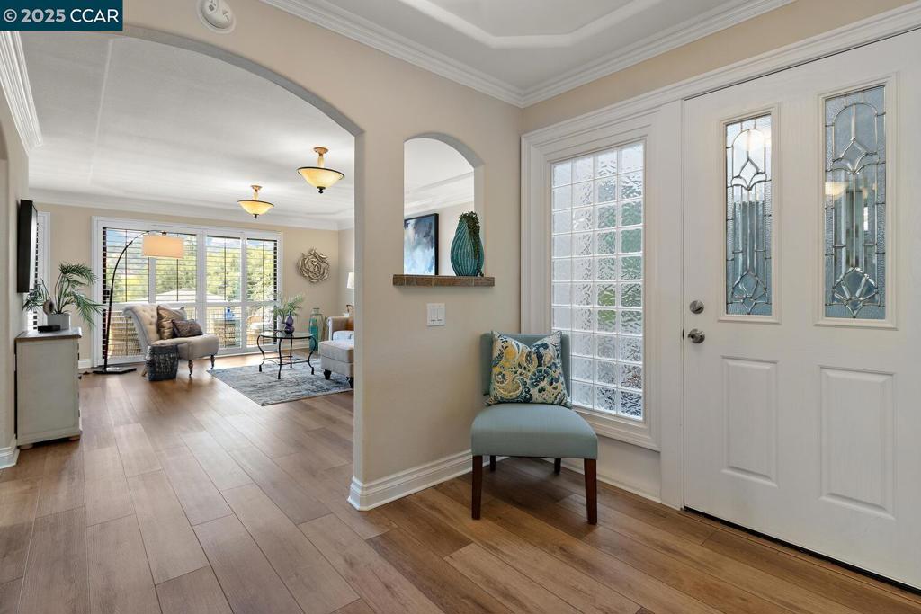 Welcome to a beautiful Sonoma Wrap model in the desirable active-adult community of Rossmoor, situated on 2,000 acres in vibrant Walnut Creek. This lovely two bedroom, one bathroom home has been remodeled from top to bottom and has a rare Bonus Room that makes a perfect Home Office or Den. You'll appreciate the architectural details throughout this coop like the coffered ceilings, arched entryways, and multi-layered crown molding and baseboards. The Kitchen has an abundance of cabinetry and lots of counter space, a moveable island, and a charming dining area. In the spa-quality Bathroom you'll find a stunning shower with built-in seat, designer tile work, and multiple shower heads as well as built-in mirrored cabinets surrounding the vanity. Luxury vinyl flooring throughout gives the property a simple elegance that is easy to maintain. Laundry is a breeze with a dedicated laundry room added to the enclosed wrap. Enjoy our amazing weather from the expansive open balcony overlooking the rolling Rossmoor hills. Don't miss this special end-unit property located in a charming entry with lots of guest parking and its own little neighborhood park.