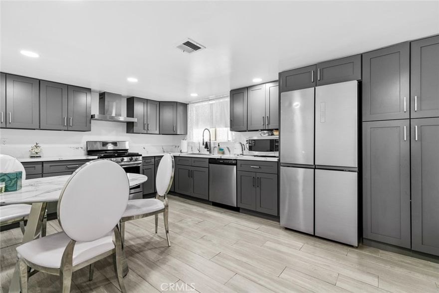 This exceptional HUGE  remodeled and spacious corner Town House unit featuring 3 bedrooms, 2.5 bathrooms, and an attached side-by-side 2-car private garage, with approximately 1,971 sqft. Situated at the rear of a fully gated community, this home offers added privacy, quiet, and abundant guest parking behind the gates. The entry level includes a private garage with direct access to a large utility and storage room with full-size laundry hookups. The main floor has a bright, open-concept living area with new luxury vinyl plank flooring, recessed lighting, a fireplace, balcony, powder room, dining area, and built-in bar. The spacious eat-in kitchen features modern cabinetry, stainless steel appliances, and space for a breakfast table. A bonus room on this level offers flexibility as a potential 4th bedroom, office, den, or playroom. Upstairs, the large primary suite includes multiple closets and an remodeled bathroom with dual vanities and a step-in glass shower. Two additional bedrooms and a full hallway bathroom complete the top floor.

Beautifully maintained and move-in ready, this home combines size, style, and location in a desirable gated community. MOTIVATED SELLER