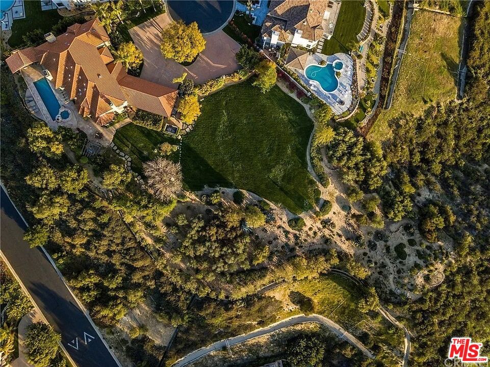 Opportunity to Build in Prestigious Mountain Park Estates. Welcome to 24030 Alder Place A beautifully designed home that blends Spanish-style architecture with modern lines and upscale finishes. Located in an exclusive 24-hour guard-gated community of Mountain Park Estates in Calabasas. Situated on over an acre at the end of a peaceful cul-de-sac, this expansive 50,000 sq ft lot offers captivating mountain views and exceptional privacy. Proposed plans showcase a striking modern farmhouse design, thoughtfully laid out to take full advantage of the surrounding natural beauty and spacious setting. Mountain Park Estates is one of Calabasas' most coveted communities, offering a serene lifestyle with top-tier amenities including private tennis courts, a putting green, playgrounds, and beautifully maintained grounds. Just minutes from top-rated schools, The Commons at Calabasas, and fine dining, this location combines luxury, convenience, and security. Don't miss the chance to bring your dream to life in this exclusive enclave. Whether you're building your forever home or investing in a premier lot, 24030 Alder Place is where vision meets opportunity.