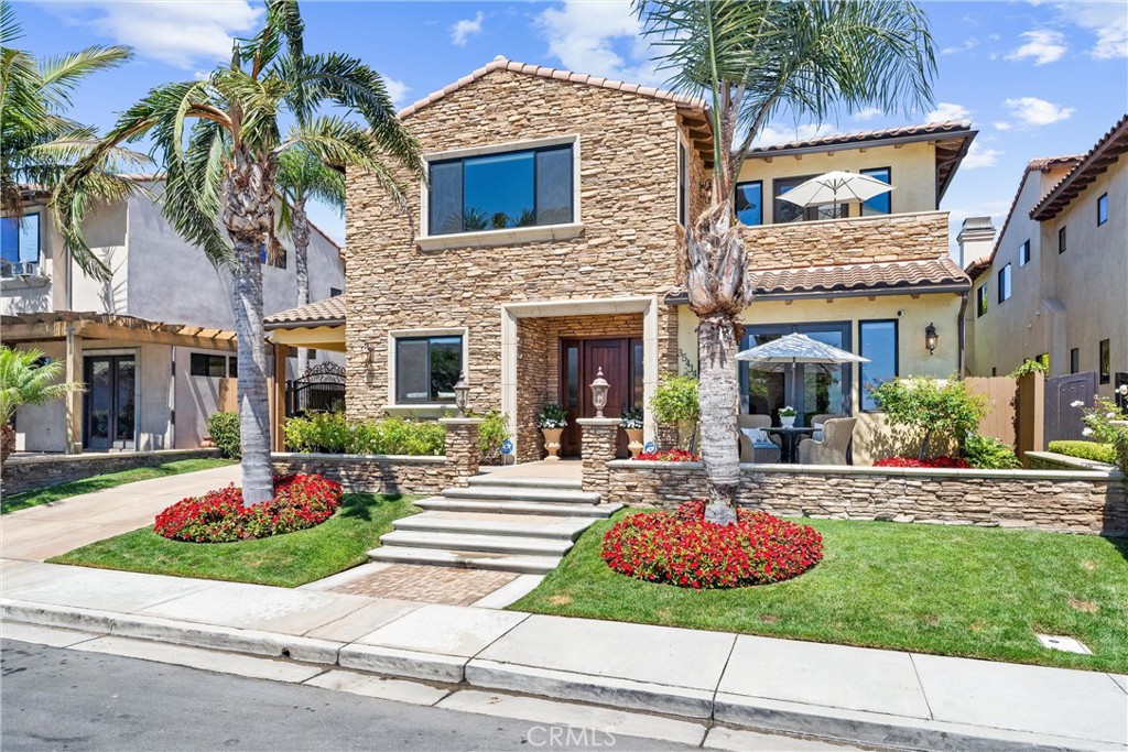 Opportunity knocks! Beautiful ocean-view custom-built impeccably maintained entertainment home with pool and jacuzzi! Elegant and charming home with amazing curb appeal, exterior stone & artisan lighting. Main floor has formal living and dining rooms with ocean view, entertainer's kitchen with eating area, family room with fireplace, bedroom/office, and bathroom with walk-in shower. Second story has main bedroom suite with seating area and balcony with ocean view; 3rd. bedroom with full bath; large 4th. bedroom with ocean view; huge 5th. bedroom (or bonus/media/game room/office) with fireplace and pool view; hall bathroom with walk-in shower; and laundry room with utility sink & built-in cabinetry. Gourmet kitchen has granite countertops, travertine back splash, under-cabinet lighting, walk-in pantry, over-sized center island with seating arrangement, stainless steel Viking appliances, and tons of storage space in wood cabinetry. Master suite has fireplace, dressing room with tall custom cabinetry, bathroom with double sinks, separate tub, and dual-headed shower with glass enclosure. French doors lead from living room and from master suite to front outside porches to enjoy the ocean breeze, and from family room to entertainer’s back patio to enjoy the amazing hardscape, landscape, recently built pool and jacuzzi. Travertine floor downstairs, in all the bathrooms, the laundry room, and the patio's entertaining area; top-of-the-line recently installed wood flooring on stairs, upstairs hall and in all the bedrooms. Exquisite details throughout include 10' tray ceilings with amazing crown molding, 8' Mahogany doors, 7.5" baseboards, cathedral ceilings, ceiling fans in all bedrooms, recessed lighting, designer's paint, and new Roman window blinds. Carriage driveway is suitable for up to 4 vehicles; 2-car garage with attic space; huge backyard with lush landscape; amazing pool with waterfalls, jacuzzi, BBQ grill, refrigerator, and entertainment area; and lighted/gated dog run on the side patio. Beach location is close to shopping & entertainment. Also, NO HOA dues and NO Mello-Roos. This is a must see!