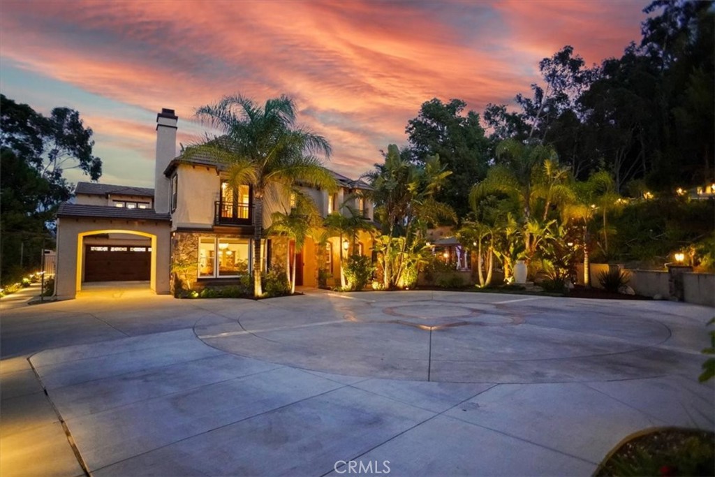 Be Prepared to Be Seduced! Welcome to your private sanctuary, a truly resort-like entertainer’s estate nestled behind secure electric gates and perched atop a long private drive. This is Southern California living at its finest, where every day feels like a vacation and serenity surrounds you. More than a home - you’re buying a lifestyle. Boasting nearly 3,800 square feet of stylishly updated living space, this spectacular residence features 4 spacious bedrooms (with potential for 6!), 4 bathrooms, and sits on an expansive half-acre+ lot that feels worlds away from the ordinary. Whether you're entertaining or simply unwinding, this home offers the perfect backdrop for any occasion. Outdoors, let yourself be swept away by the resort-inspired amenities: a sparkling pebble-finished pool and spa with Baja shelf, custom BBQ and outdoor kitchen, covered TV lounge with fireplace, multiple pergolas, view cabanas, a putting green, and lush, manicured grounds that exude tranquility and privacy. It’s a setting so serene, you’ll forget you're just minutes from the city. Inside, designer touches abound. From wood-look tile flooring and crown moldings to French doors and custom motorized window treatments, no detail has been overlooked. The heart of the home is a chef’s dream kitchen featuring Quartzite countertops, high-end stainless steel appliances, a pot filler, double pantry, and a center island with breakfast bar -perfect for gatherings and creating memories. The floorplan flows effortlessly and is bathed in natural light, with formal living and dining rooms, a family room, a library/study, and an expansive upstairs loft/media area. Retreat to your luxury primary suite with its own sitting area, view balcony, dual walk-in closets, and a spa-inspired bath with soaking tub, large walk-in shower, and dual vanities. Additional features include a 3-car garage, RV parking, a large motor court, fully owned solar panels, and dual-zone HVAC -offering both convenience and cost-saving efficiency. This is more than a home -it’s a serene escape, a statement, and a lifestyle you’ll never want to leave.