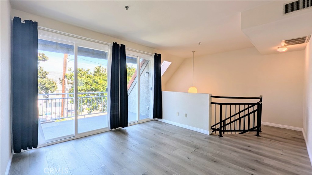 This beautifully maintained 3 bedroom, 2 bath two-story home sits on a peaceful tree-lined street. With approximately 1,500 square feet of living space, the layout is open and filled with natural light from newer dual pane windows. The spacious downstairs primary suite includes a generous walk-in closet and a stylishly upgraded bathroom featuring a tile walk-in shower. Two additional bedrooms are located down the hall, along with under-stair storage, a laundry closet with washer and dryer hookups, and a second upgraded bathroom with quartz countertops and a shower/tub combo. Upstairs, enjoy a bright and airy living and dining area that opens up to a large balcony with treetop views. The updated kitchen features quartz countertops, shaker cabinets, a stainless steel sink, a high-performance Maytag dishwasher, and a Samsung oven and stove. A separate oversized den offers flexible space for work or play. Additional highlights include central heat and air conditioning plus secure gated access to a dedicated 2-car garage with built-in storage cabinets. Located just blocks from downtown Alhambra, Almansor Park, schools, and minutes from Downtown Los Angeles, this home combines comfort and accessibility in a sought-after neighborhood.
